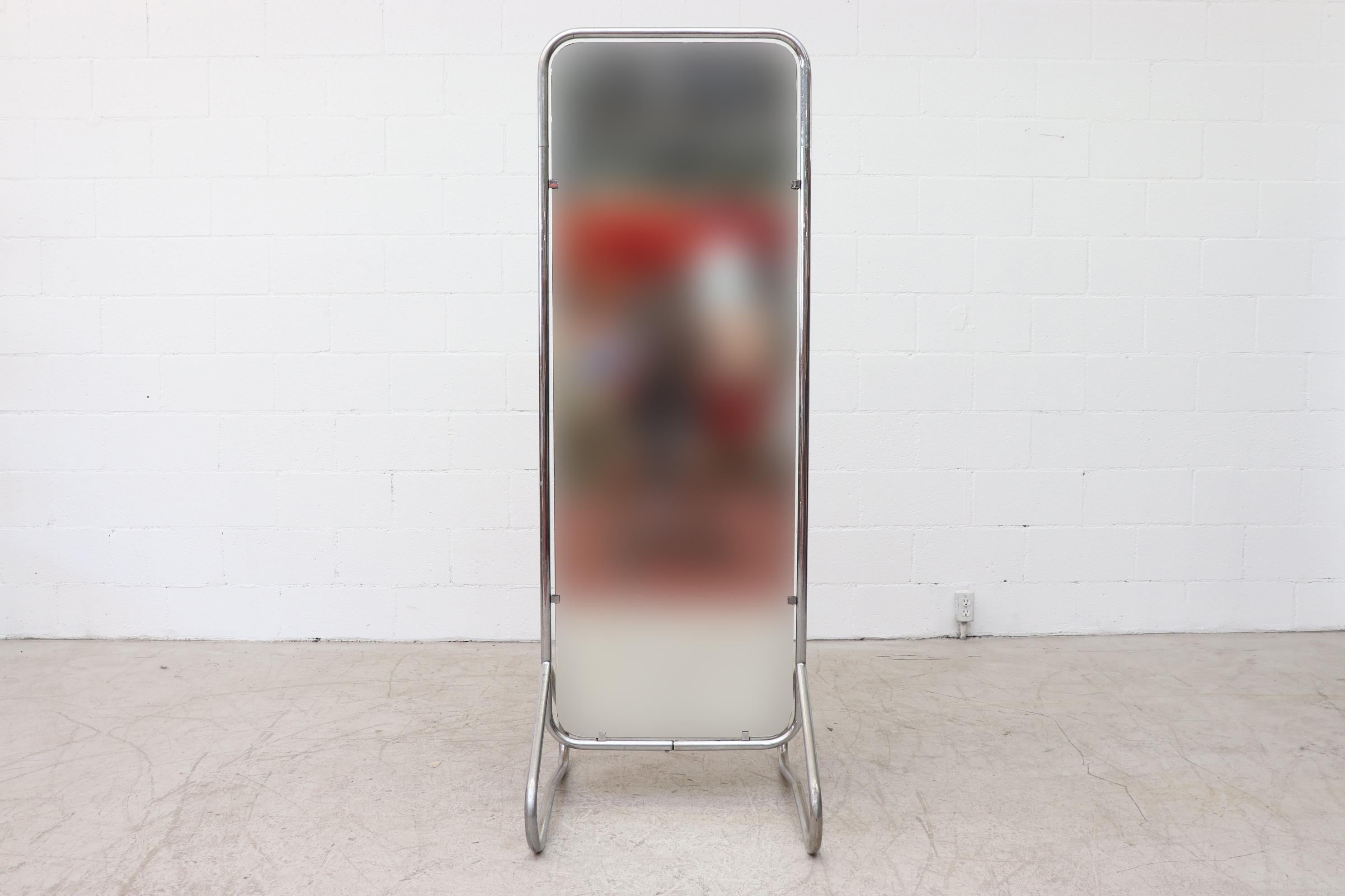 Rare Gispen standing full length mirror with tubular chrome frame in original condition with visible chrome pitting and scratching, visible scratch to back of mirror that shows on the front. Wear is consistent with its age and usage. Other similar