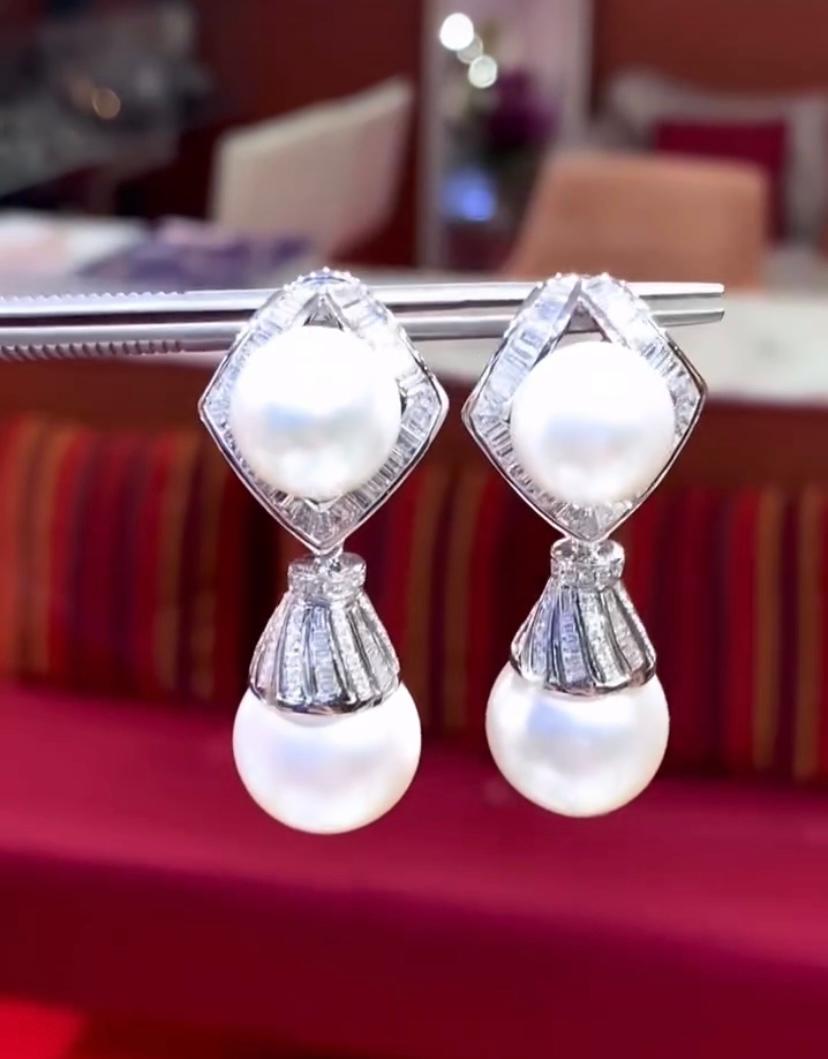An exquisite South Sea Pearls and Diamonds pair of earrings.
The earrings features a delicate arrangement of sparkling diamonds in the shape of intricate design , which adds a touch of femininity and grace .
Interspersed between the diamonds part