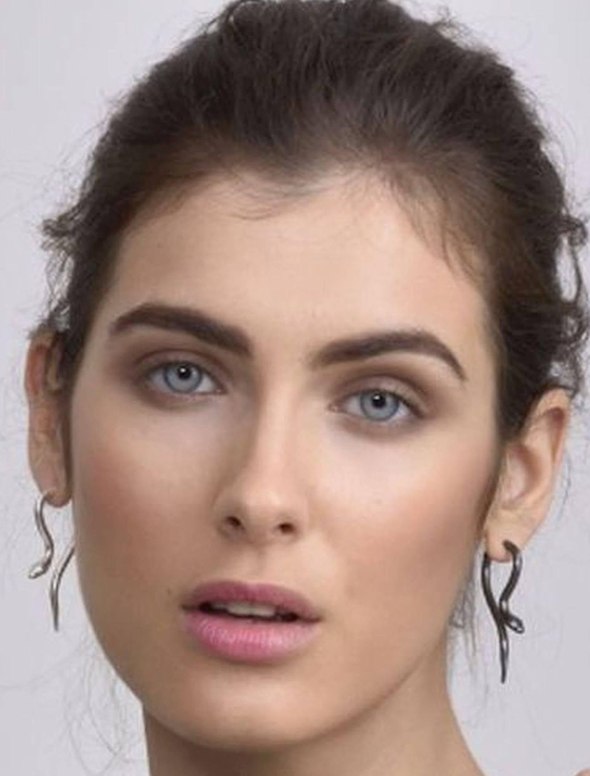 Giulia Barela's Hooked gold plated bronze earrings: small snakes play with the ears, going beyond and piercing them, creating optic effects trompe l'oeil style.

All the jewels are created and hand-made in Rome and are unique creations.

Material: