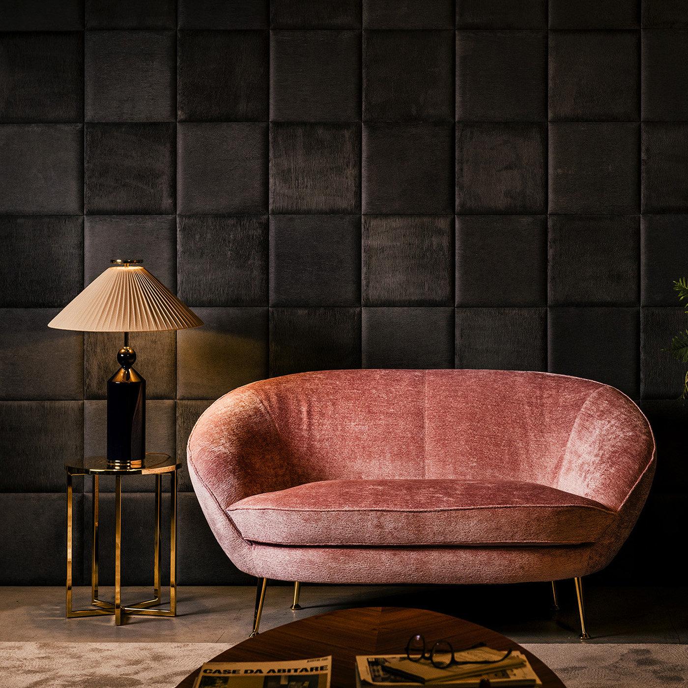 Mid-century appeal and exquisite tailoring characterize this stunning sofa with wrapped forms that will bring a unique and sophisticated look to a modern interior. The beech wood structure has a rounded back and seat cushions covered in blush pink