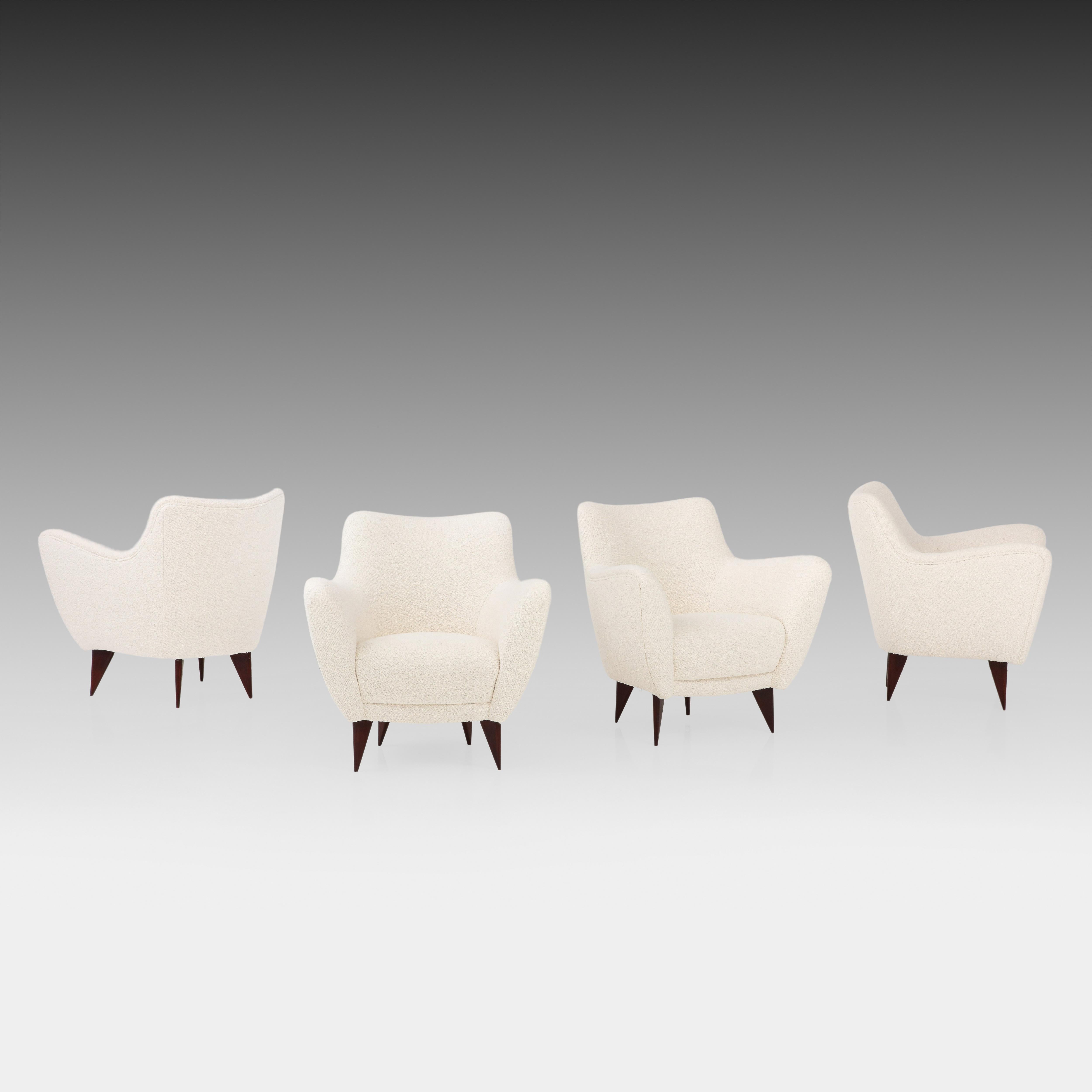 Giulia Veronesi for ISA Bergamo elegant and sculptural set of four Perla lounge chairs or armchairs with slightly curved back and gently outstretched arms ending in signature sharply tapered triangular walnut legs.  This chic model features