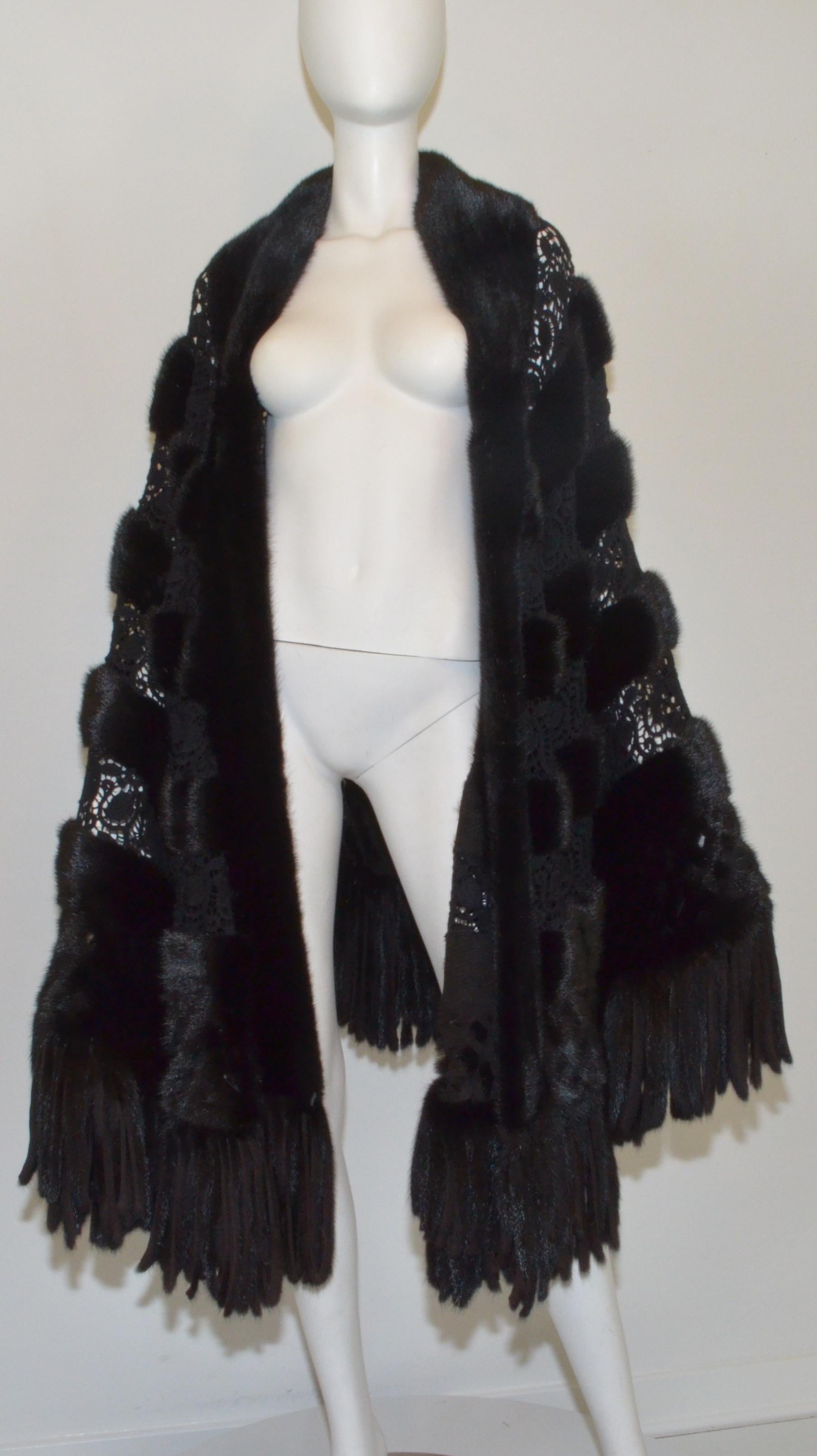 Amazing Giuliana Teso stole is featured in black mink fur with crochet lace panels and a fringed hem. Made in Italy. 

Approximate length 41''
