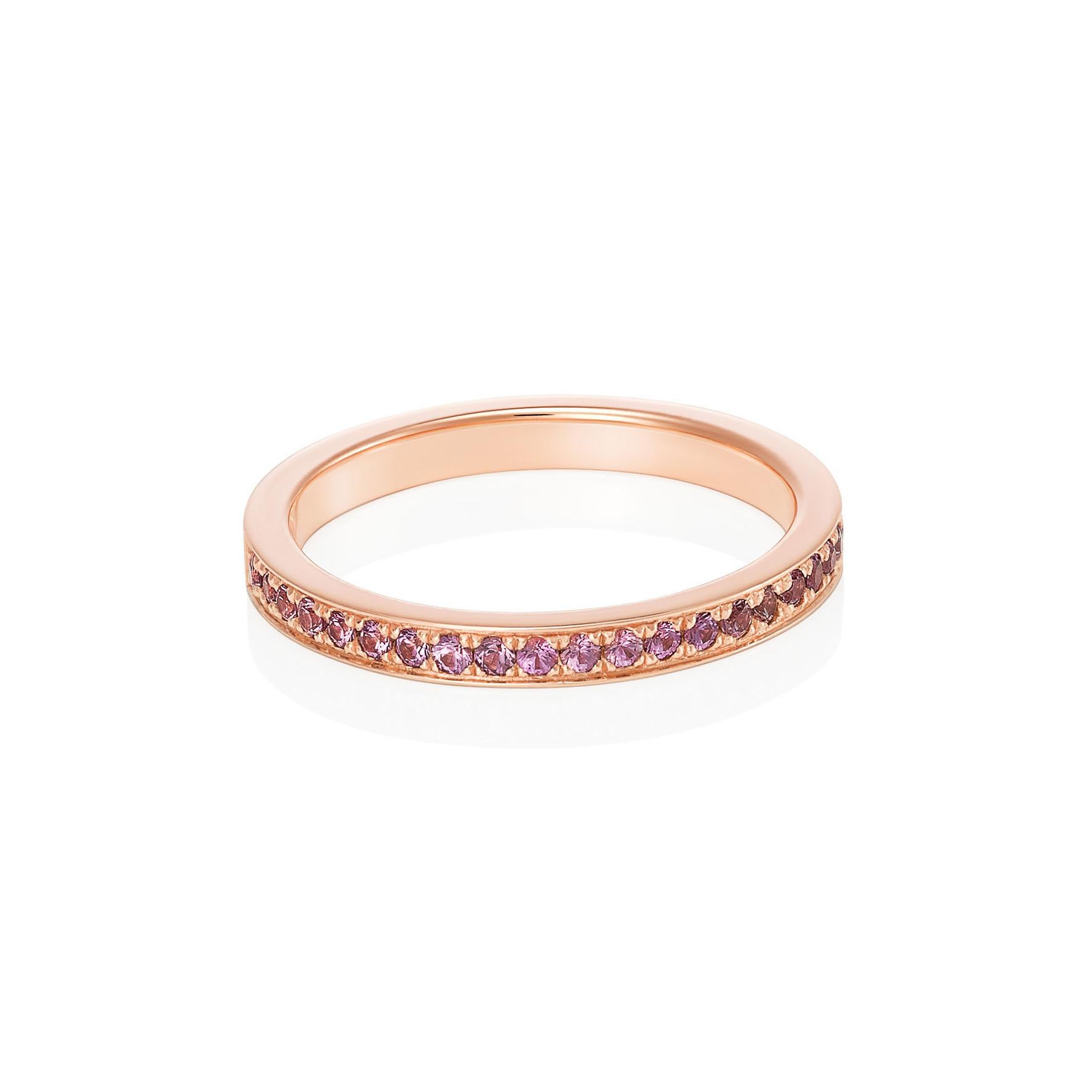 Giulians 18 karat rose gold and pink sapphire pave set ring. This ring features 26 round brilliant cut pink sapphires pave set in a single line to two thirds around, with a total weight of 0.29 carats.  The band measures 2.3mm in width and 1.65mm in