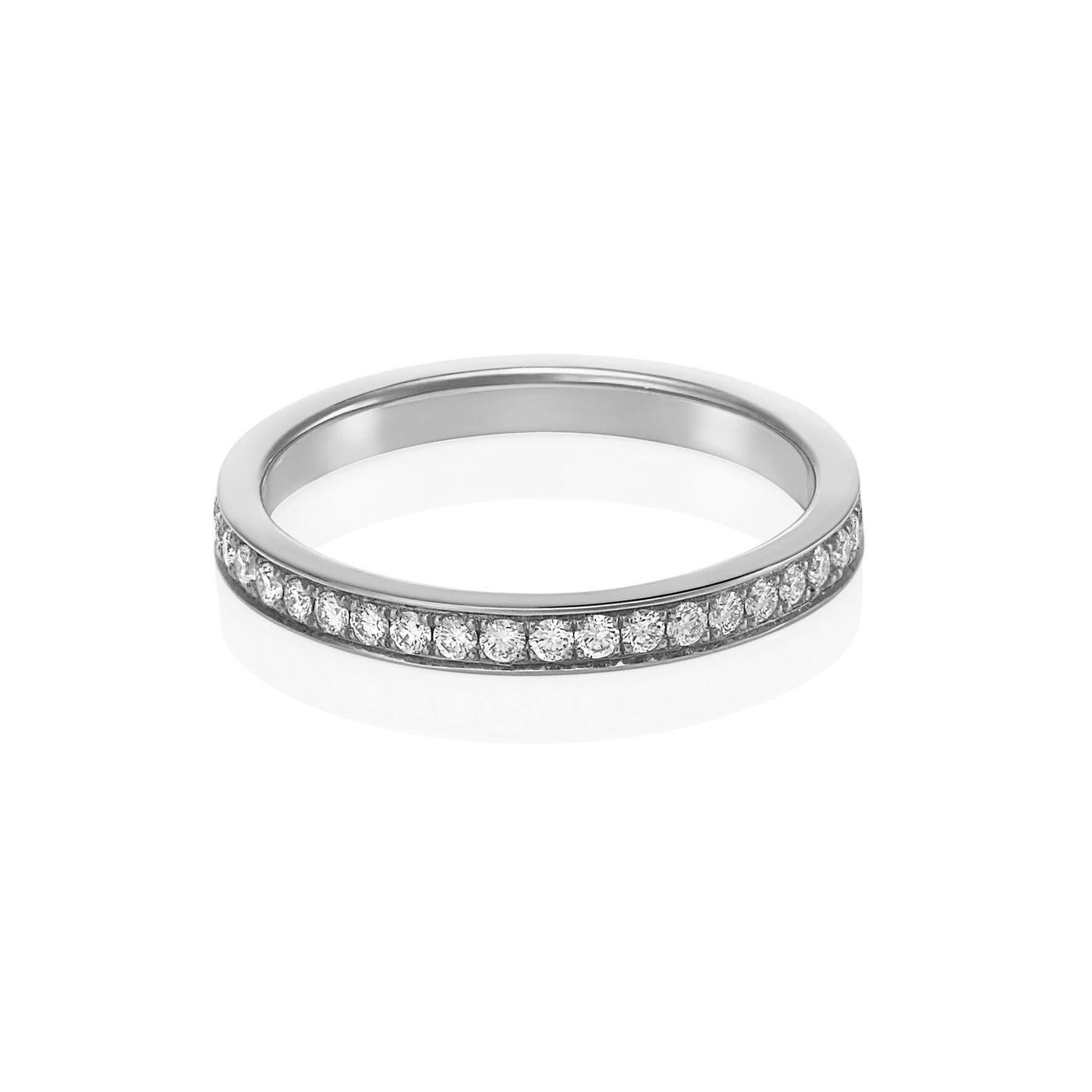Giulians 18 karat white gold and white diamond pave set ring. This ring features 26 round brilliant cut white diamonds (E-F VS) pave set in a single line to two thirds around, with a total weight of 0.27ct.  The band measures 2.3mm in width and
