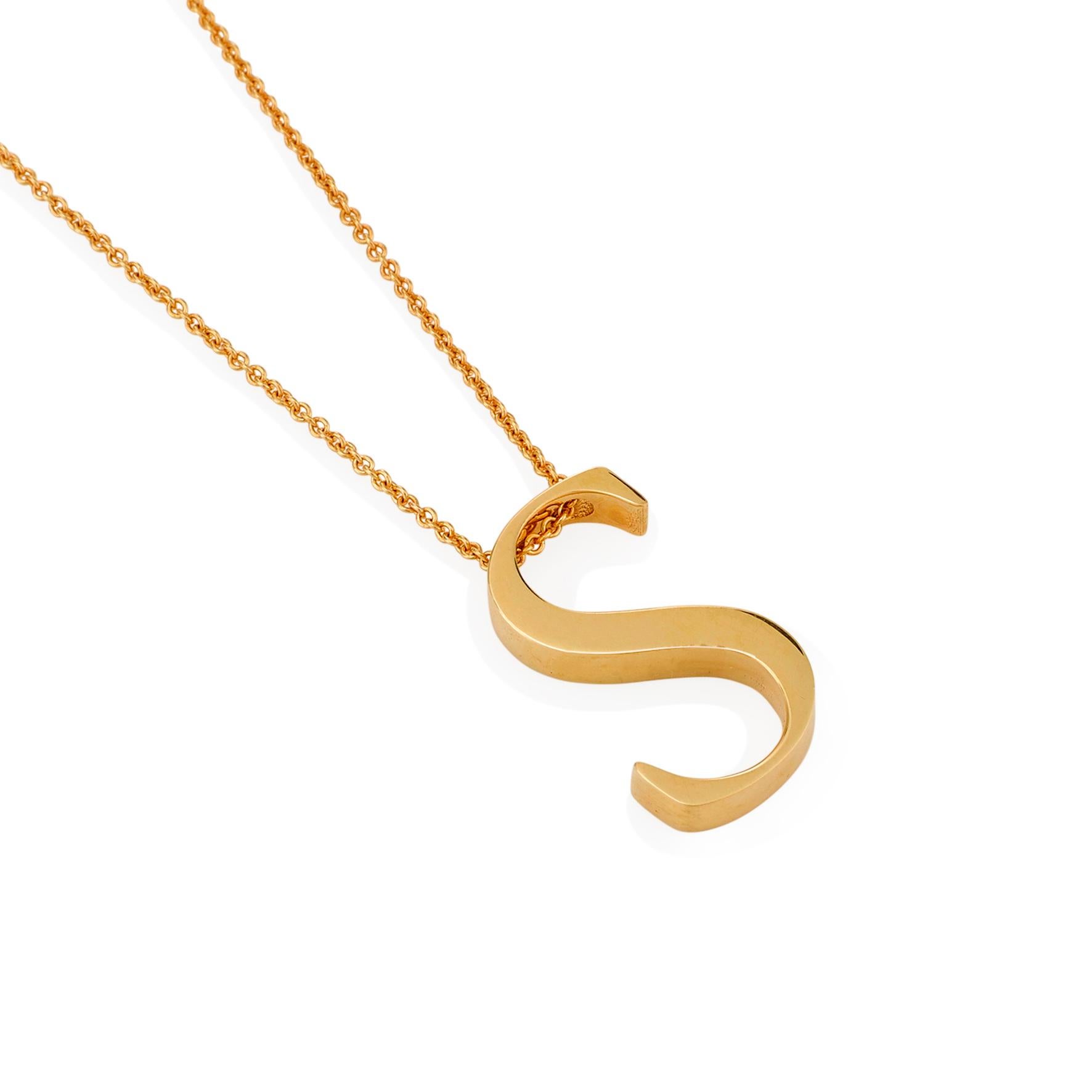 Giulians contemporary 18 karat yellow gold letter pendant.  This pendant features the letter S in a serif style font, with a flat profile and a polished finish.  The 18k 1mm trace chain runs through the top of the S, measures 47 cm (18.5 inches) in