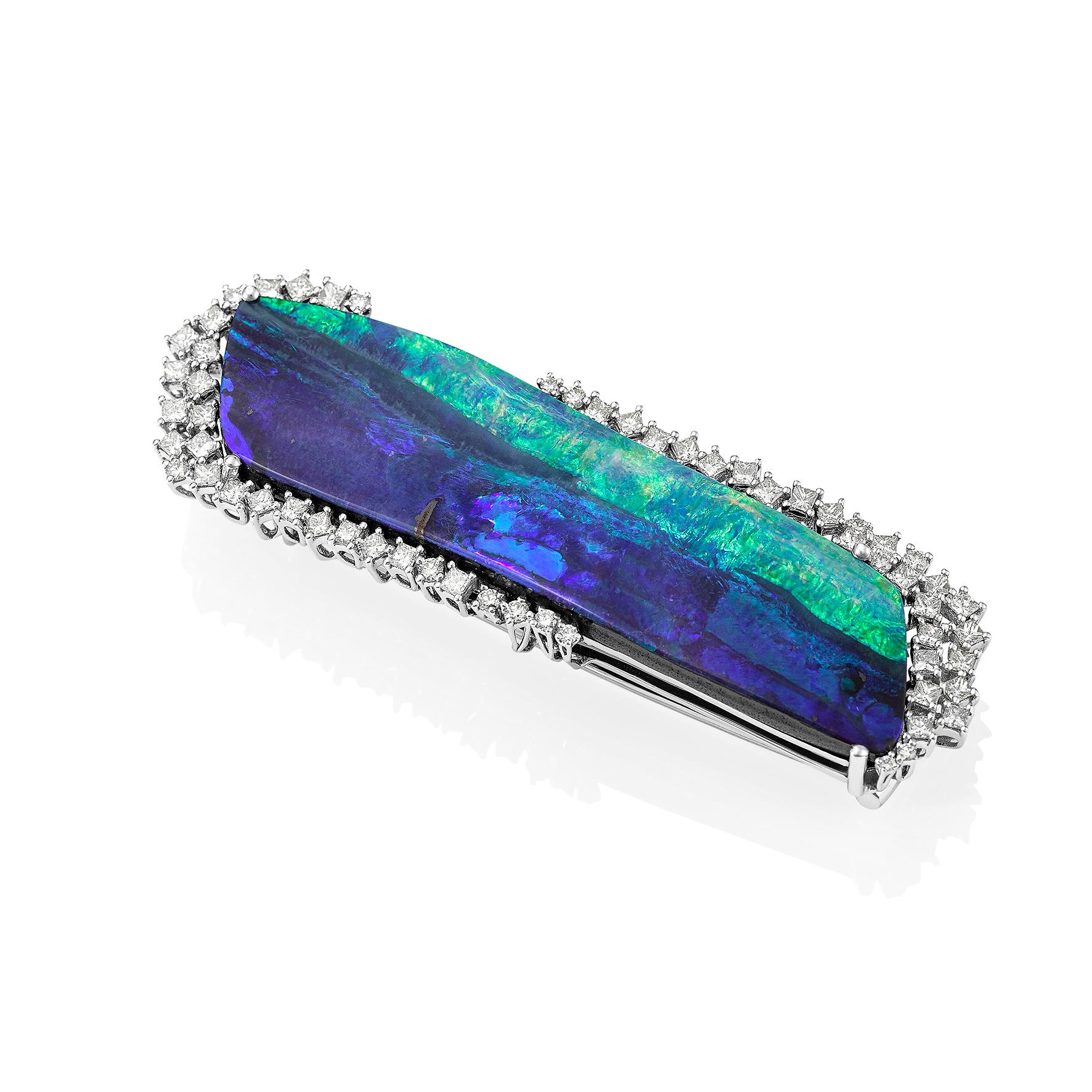 Giulians contemporary handcrafted 18 karat 56.44ct Australian Boulder opal and diamond brooch.  The natural solid Boulder opal, from Queensland Australia, displays bright blue-green play-of-colour and weights 56.44ct.  The opal is surrounded by a