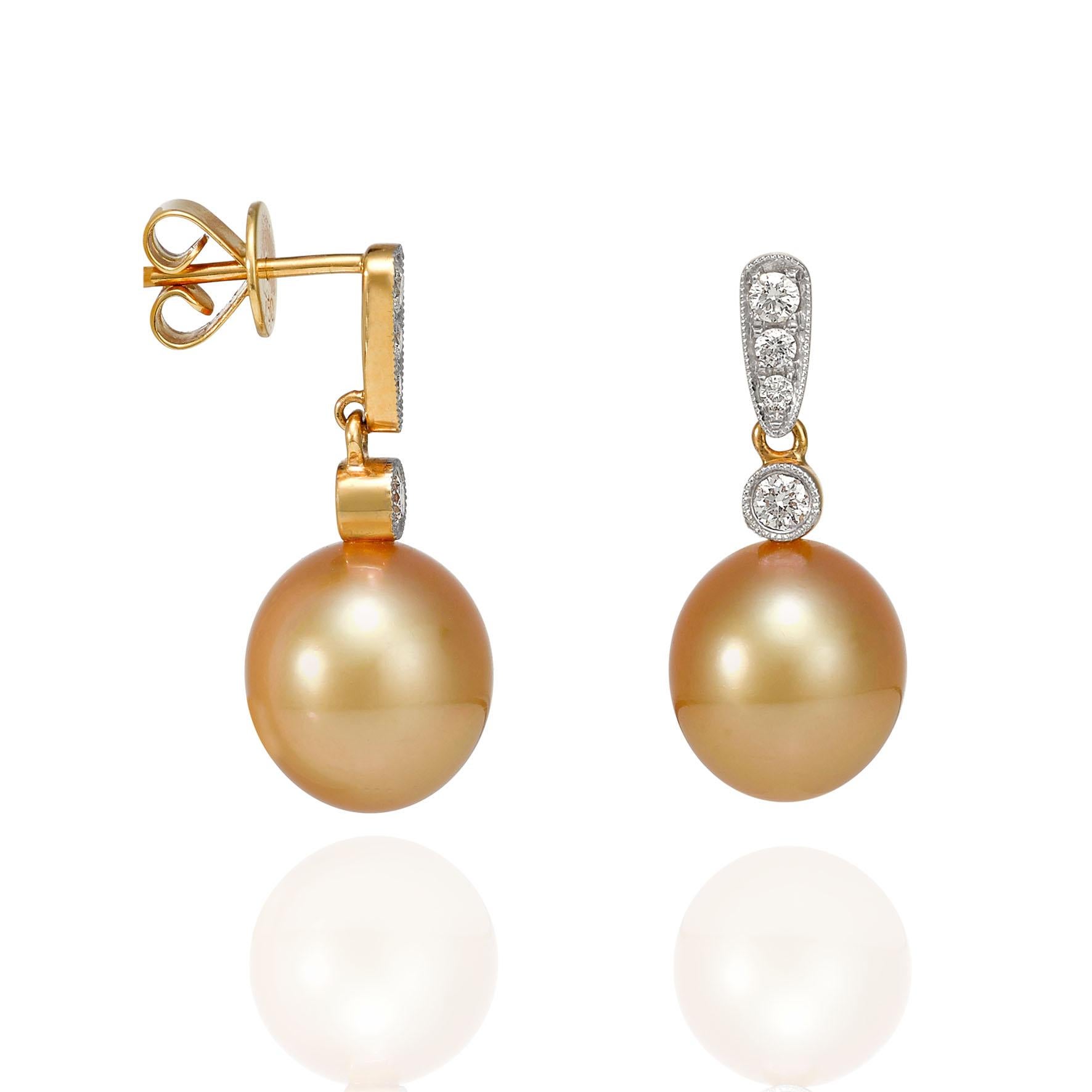 Giulians 18 karat Golden South Sea Pearl and Diamond Earrings.  Each earring features a 10mm oval shaped, gold cultured pearl with a bright lustre and smooth surface.  The pearls have been set into 18 karat yellow and white gold and diamond drops