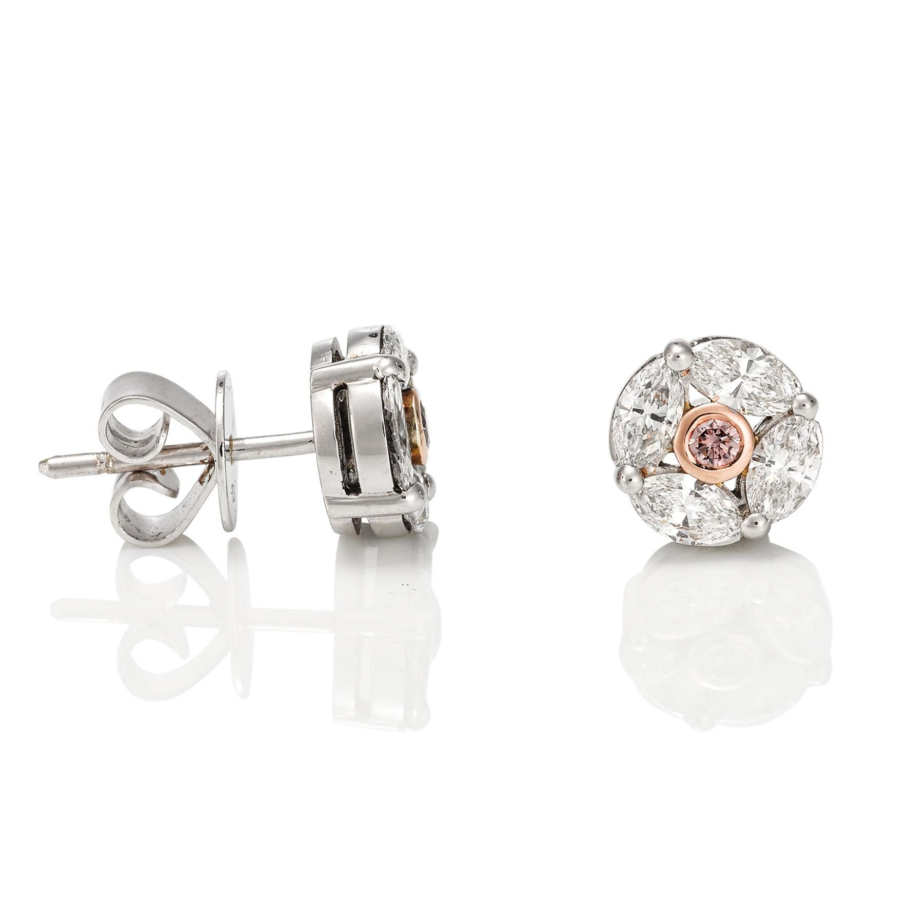 Giulians 18 karat rose and white gold diamond earrings.  Each earring features a round brilliant cut 0.05ct pink champagne diamond (PC1 - Si) set in 18 karat rose gold bezel setting.  The pink diamonds are surrounded by a cluster of 8 marquise cut