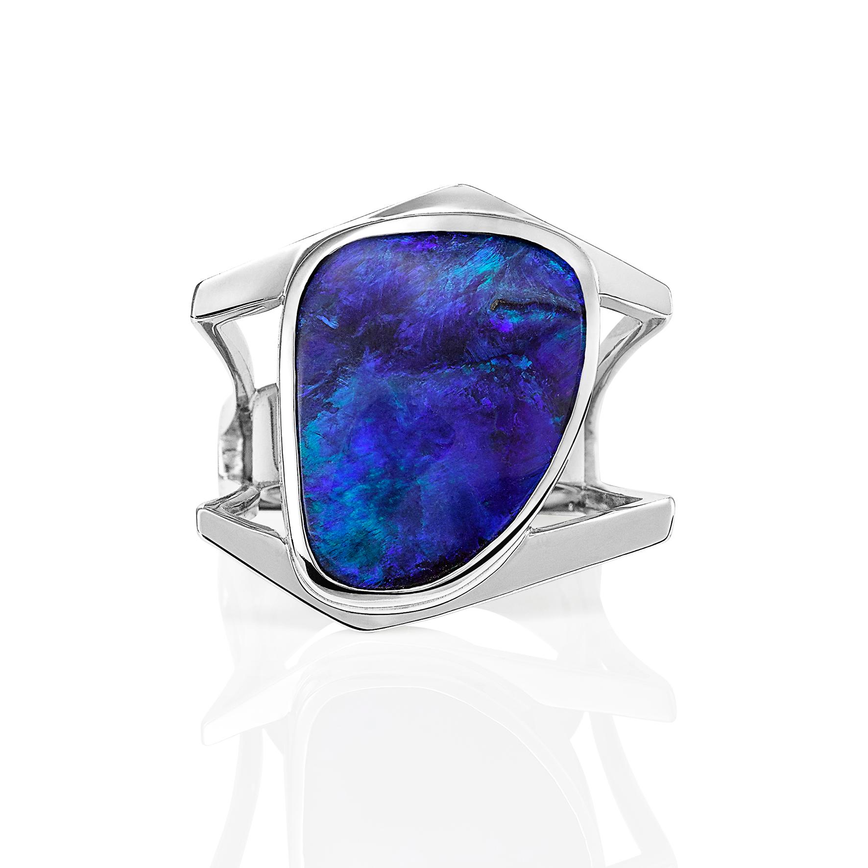 Giulians contemporary 18k 19.26ct Australian Boulder Opal Ring.  This cocktail ring showcases a natural solid boulder opal, from Queensland, with bight blue and green play-of-color.  The opal has been bezel set  within a handcrafted 18 karat white