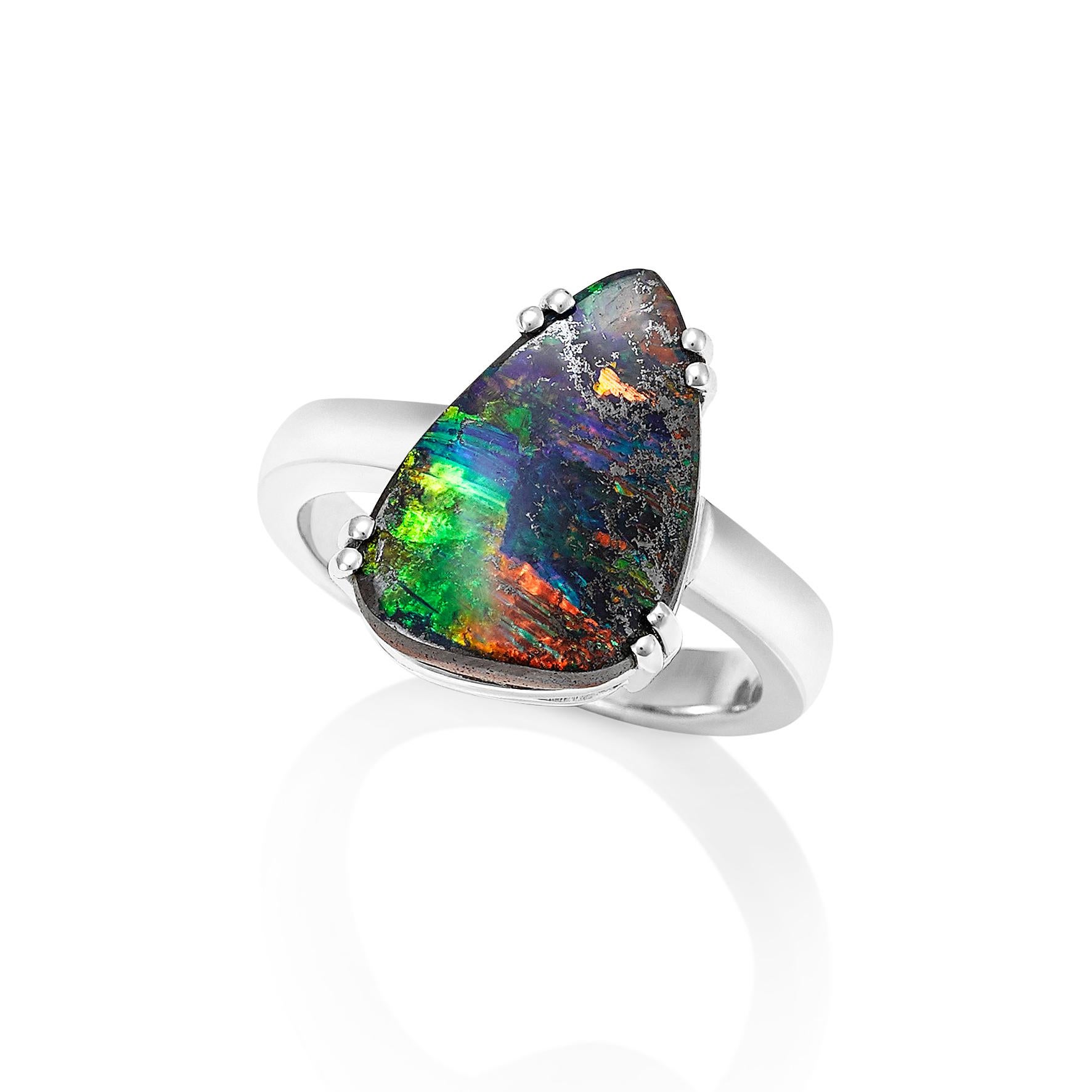 Giulians contemporary 18 karat Australian Boulder Opal Ring.  This cocktail ring showcases a 4.80ct natural solid boulder opal, from Queensland, with mysterious blue, green and red fire.  The opal has been prong set  within a handmade 18 karat white