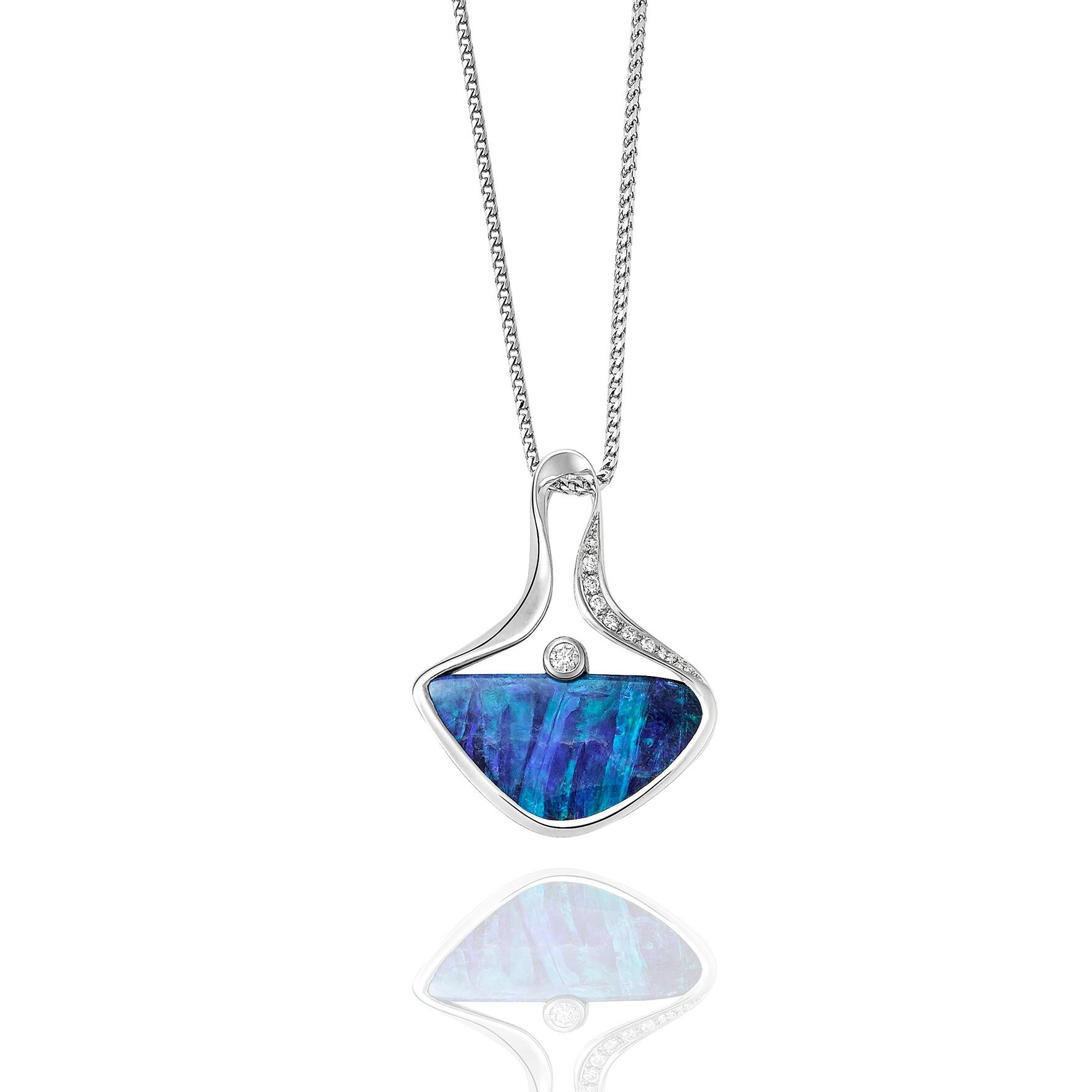 Giulians contemporary Australian boulder opal pendant necklace. This contemporary pendant features a 7.50ct natural solid opal from Queensland, with bright blue play-of-colour. The opal is semi bezel set in 18ct white gold, and is accented by a