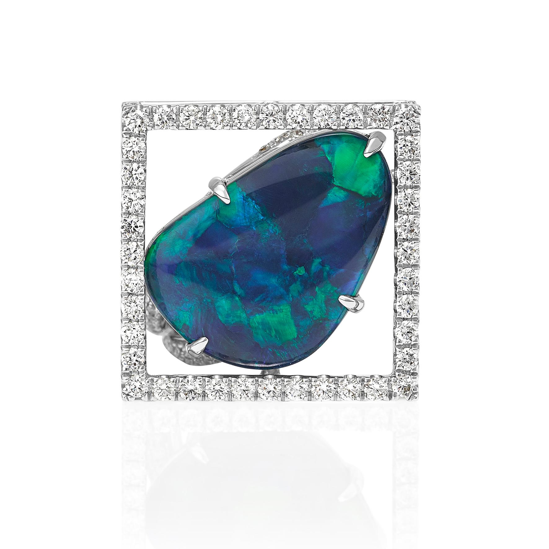 Giulians contemporary 18 karat Australian Black Opal Ring.  This cocktail ring showcases a 7.88ct natural solid black opal, from Lightning Ridge, NSW, with blue and green play-of-color.  The opal has been prong set  in a handcrafted 18 karat white
