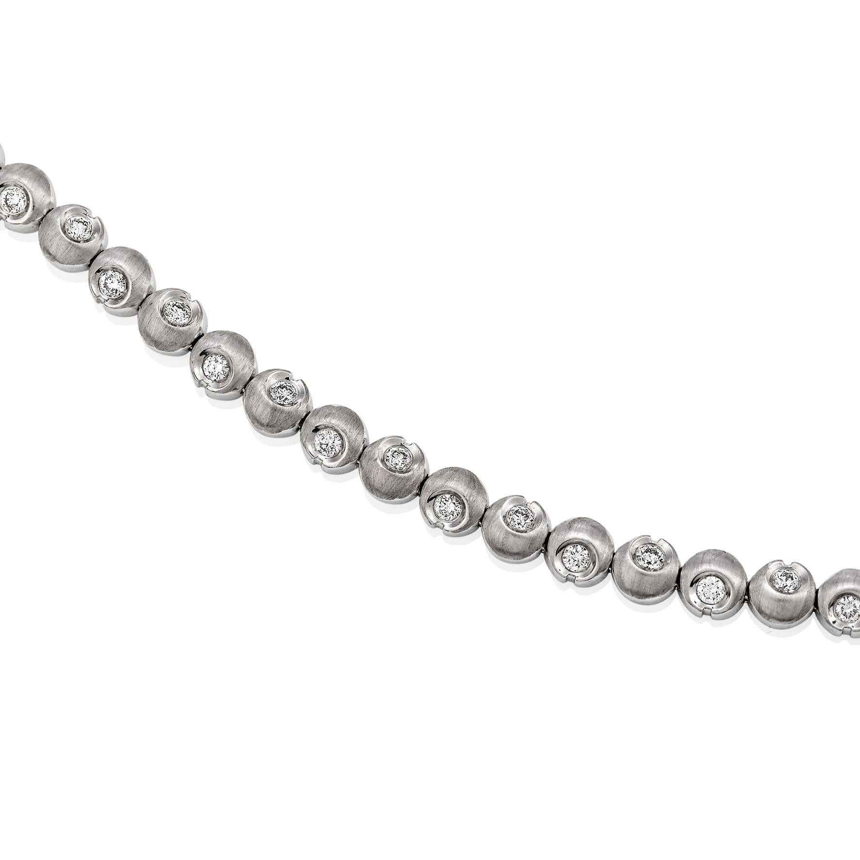 Giulians contemporary 18 karat white gold diamond bracelet.  This bracelet features 36 round brilliant cut diamonds (36=1.10ct G VS), each semi-bezel set within a half moon shaped link.  The top of the bracelet has a brush textured finish and