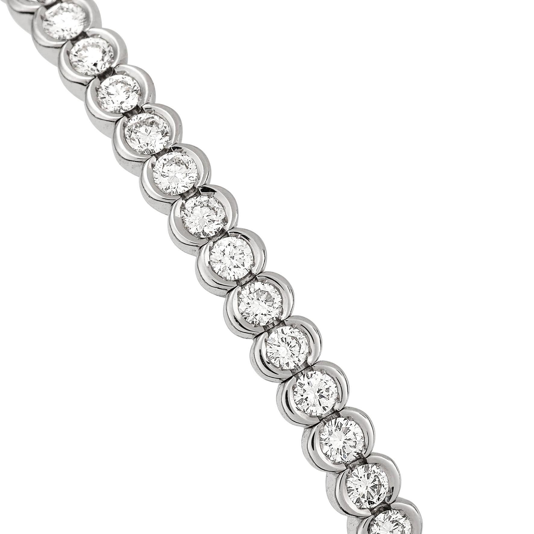 Giulians contemporary 18k white gold and diamond bangle.  This bangle features 31 semi-bezel set round brilliant cut white diamonds with a total weight of 1.30ct (G VS).  The internal measurements of the oval bangle is 57.75 mm (2.27 inches) wide