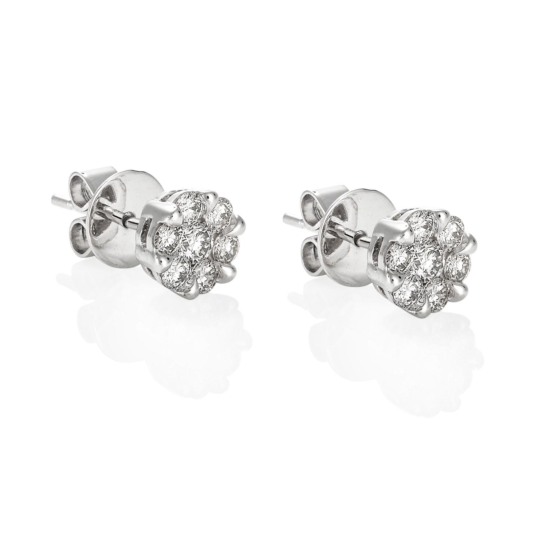 Giulians 18 karat white gold diamond set stud earrings.  Each earring features 6 round brilliant cut diamonds in prong settings and one larger round brilliant cut diamond set in the centre.  The total diamond weight is 14=0.90ct (G-H/VS-Si).  The