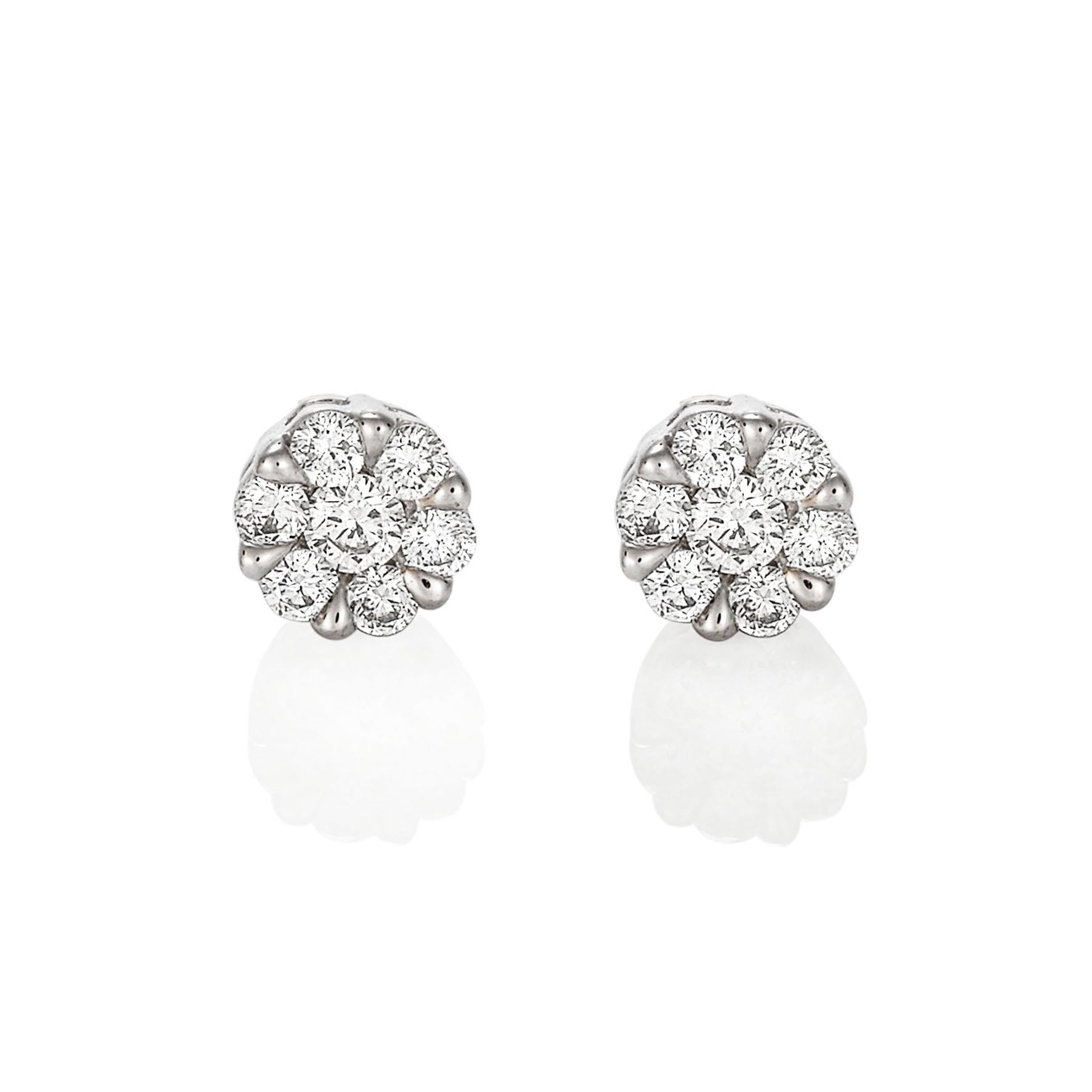Giulians 18 karat white gold diamond set stud earrings.  Each earring features 6 round brilliant cut diamonds in prong settings and one larger round brilliant cut diamond set in the centre.  The total diamond weight is 14=0.31ct (G-H/VS-Si).  The