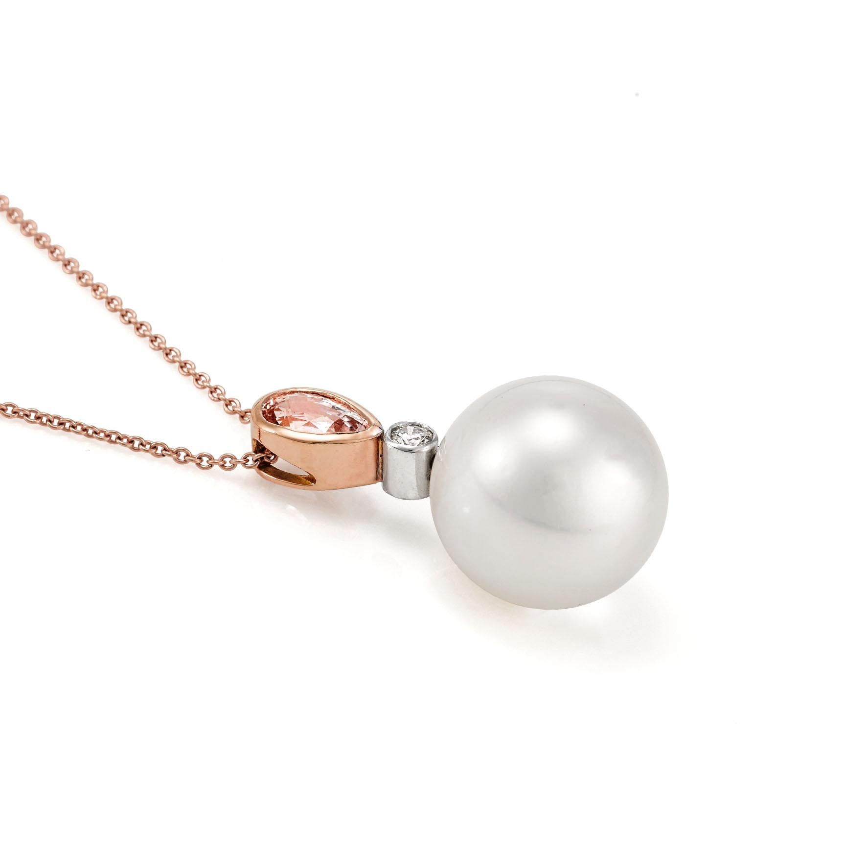 Giulians 18 karat Australian South Sea pearl, diamond and padparadscha sapphire pendant. This pendant features a top quality 14.7mm round, south sea cultured pearl with a high lustre and clean surface.  The bail features a 0.08ct round brilliant cut