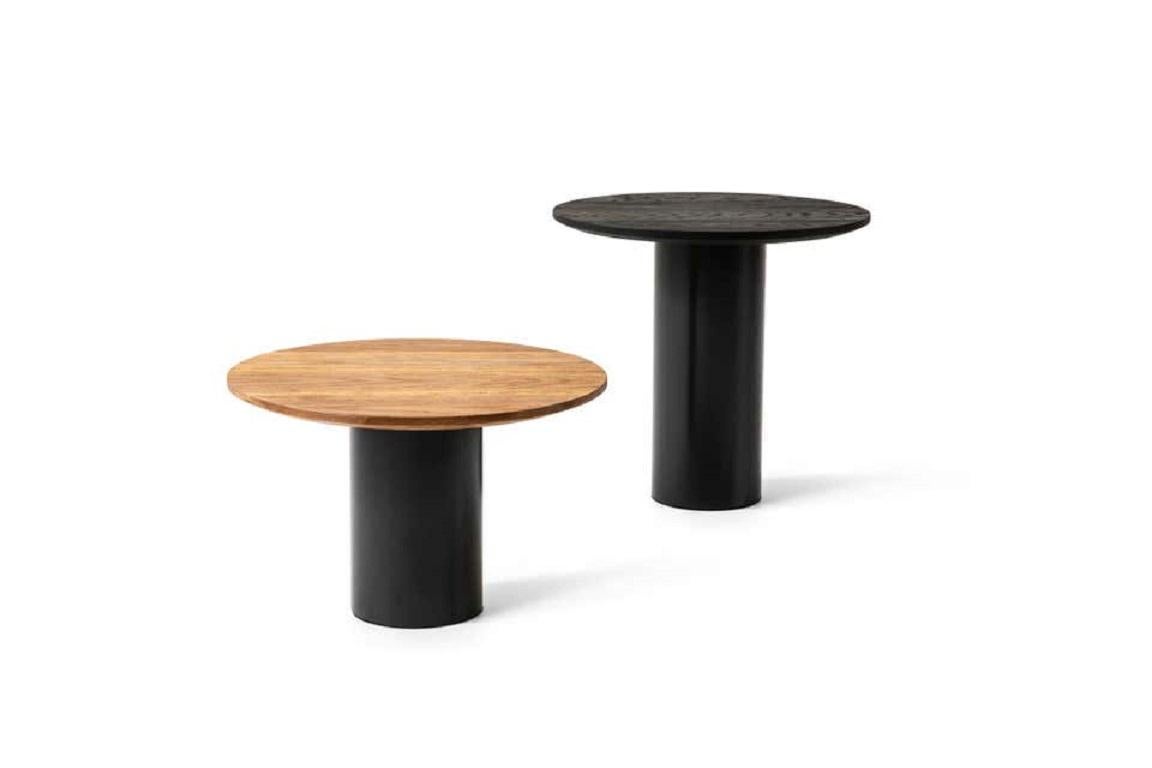 Mush coffee tables, by Giulio Cappellini, revolve around the playful use of contrasts and volumes between the robust cylindrical base and the slender circular top. Available in two heights, the Mush table is equipped with a black Matte varnish base,