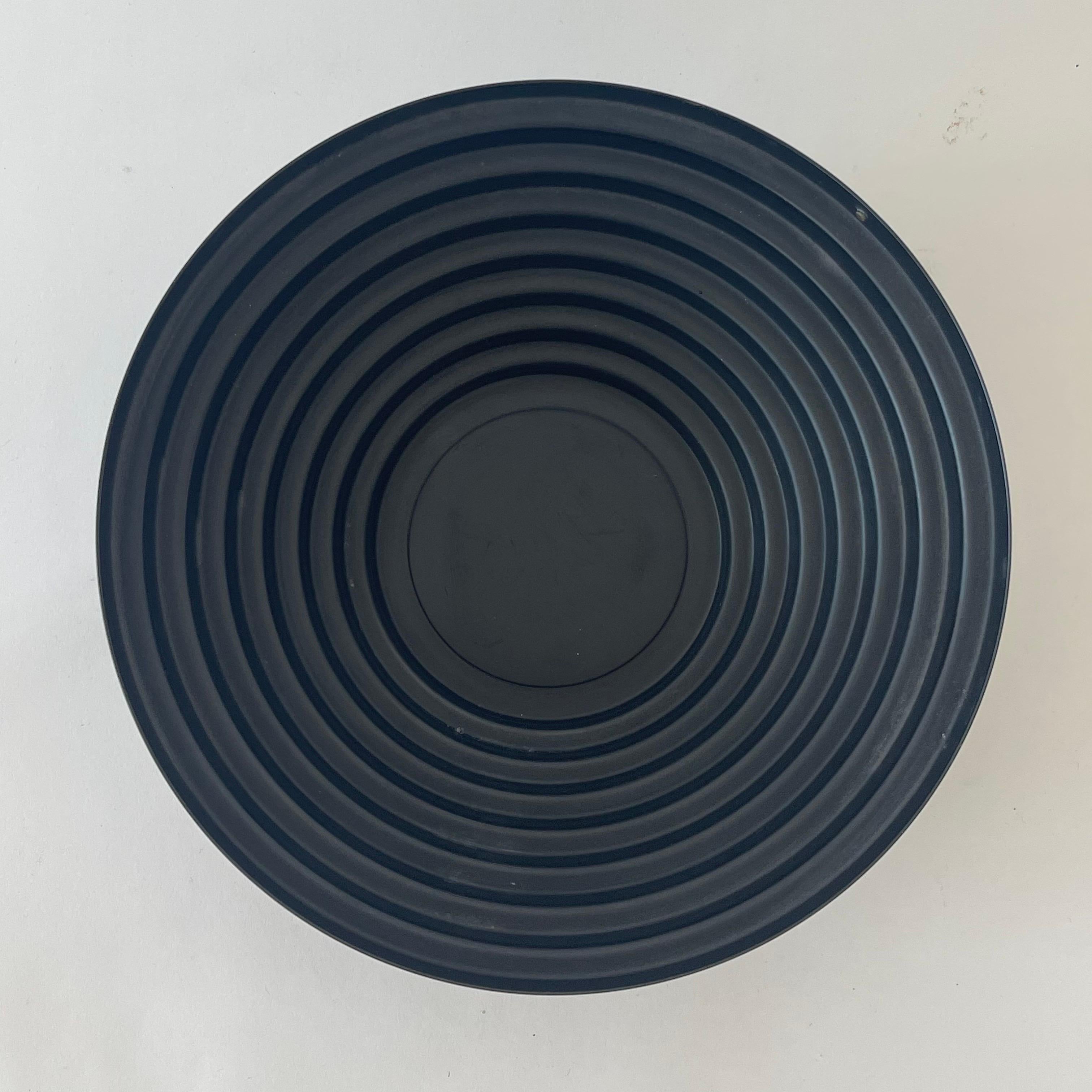 Coupe géométrique moderne pour centre de table ou coupe à fruits avec une forme de marches concentriques graduelles, réalisée en résine noire revêtue d'époxy et recouverte d'acier coloré.  Conçu par Giulio Confalonieri pour Alessi, fabriqué en