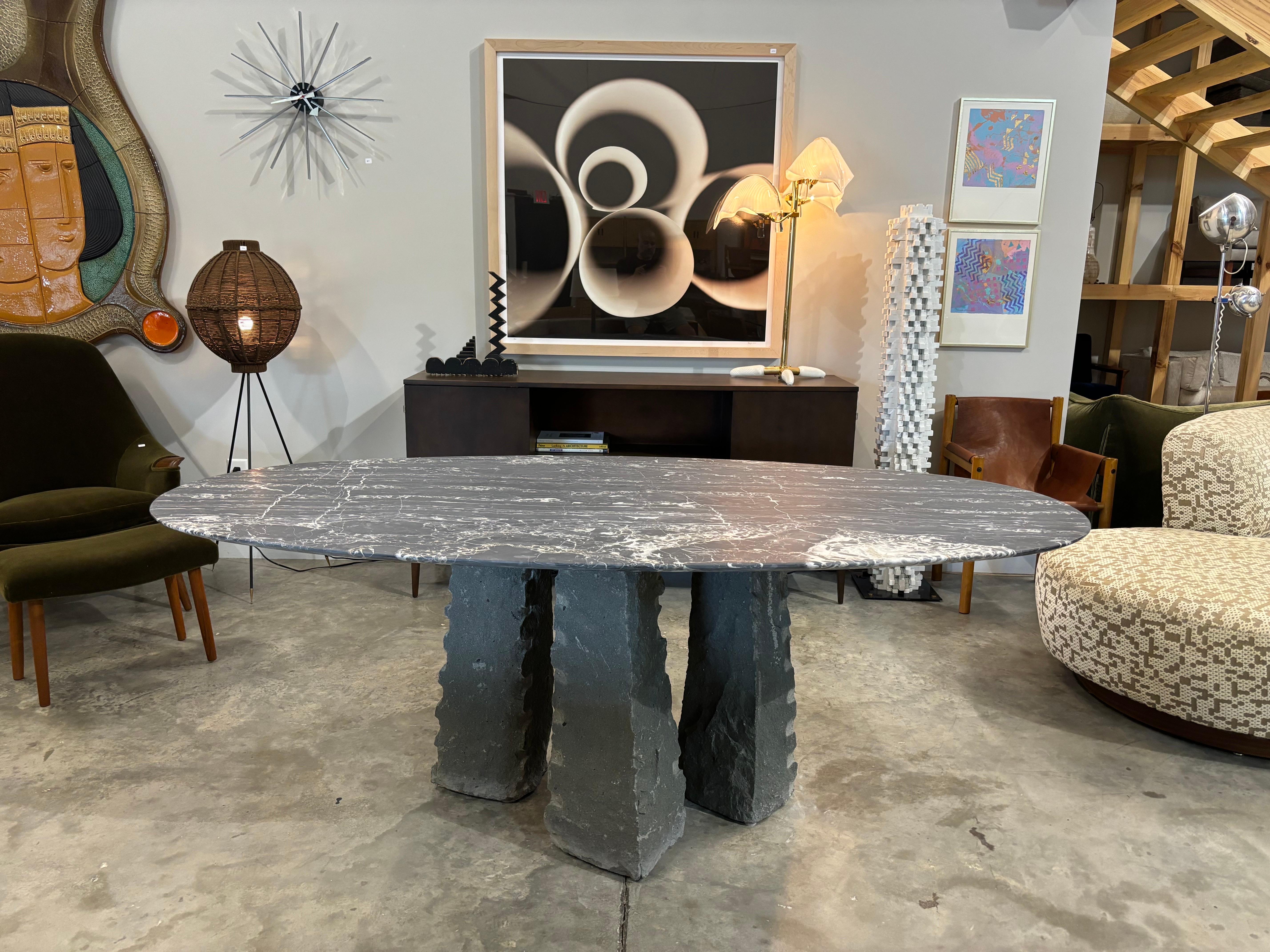 Vintage Stonehenge table legs of carved diorite with honed grey marble top.  A beautiful table that can seat up to 8 people or could be used as a center table.  

in the style of Carlo Scarpa and Mario Bellini 