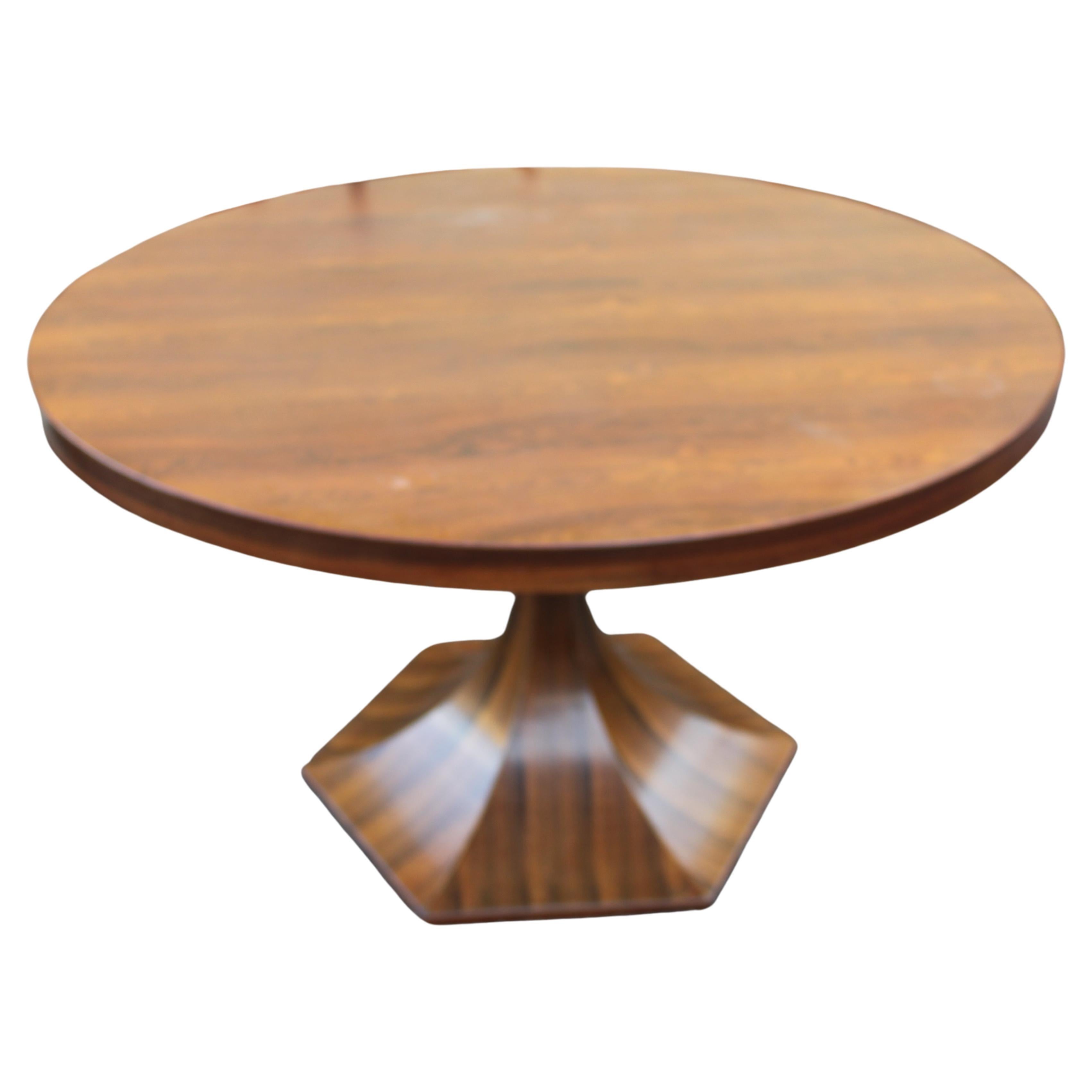 Giulio Moscatelli for Meroni round center or dining table in rare rosewood with hexagonal base, Italy, circa 1964. This exquisite midcentury table design although simple in form is extraordinary with the stark rosewood grain on the table top as well
