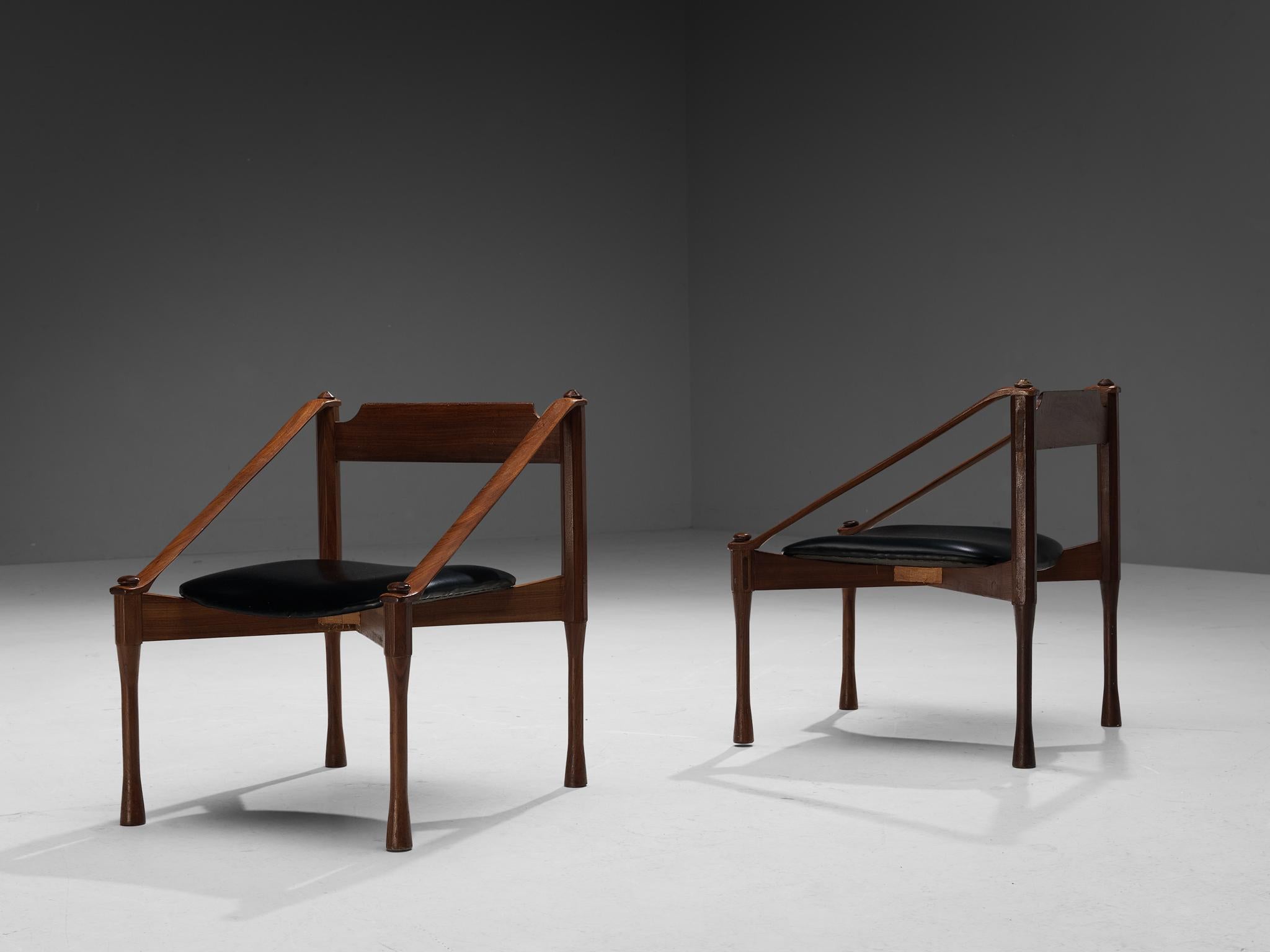 Giulio Moscatelli, pair of armchairs, walnut, leatherette, Italy, ca. 1950

These chairs by Giulio Moscatelli are distinctive in its execution. The legs are beautifully sculpted, showing concave carvings. The diagonal placed armrests give a sense of