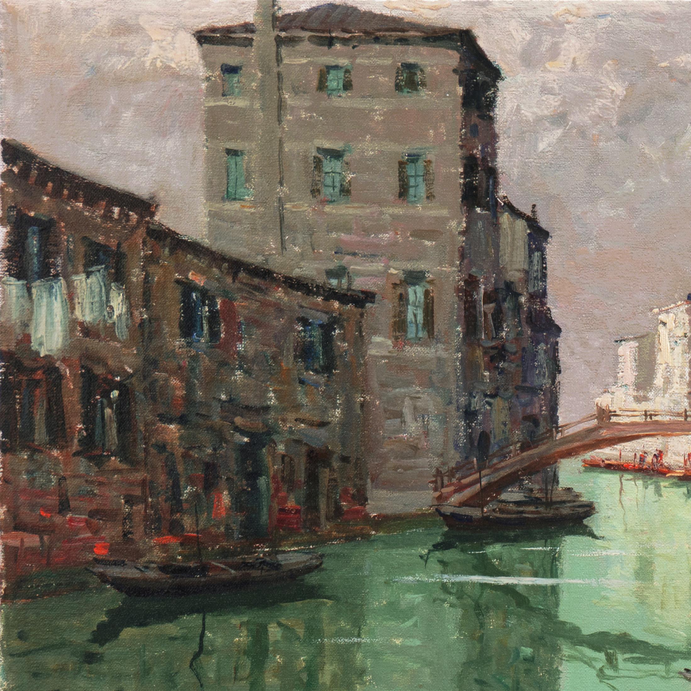 A panoramic, mid-century view of Venice's Rio della Sensa shown in the early evening with an elegant bridge reflected in still waters and pedestrians walking beside the ancient buildings.  

Signed lower right, 'G. Marino' for Giuseppe Marino