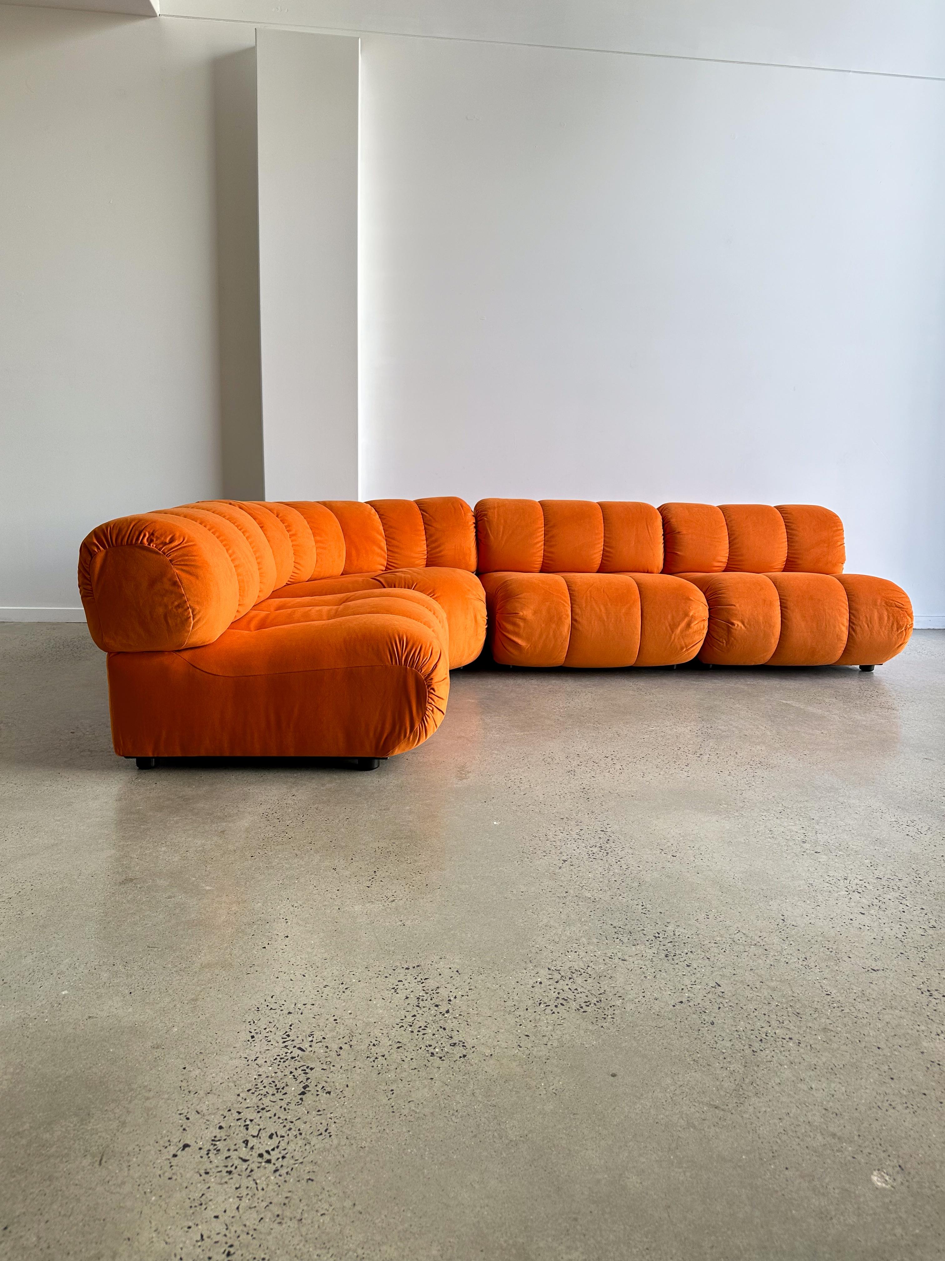 Italian Mid Century Modern orange set of four modular sofa by Giuseppe Munari for Poltronova 1970s.

Newly professionally reupholstered in Italy with Orange fabric. 

A modular sofa is a versatile seating solution that consists of individual