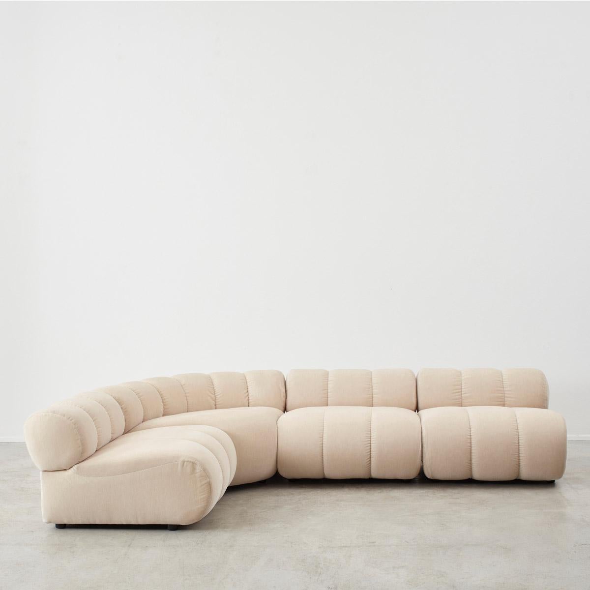 Module: H65 W90 D90cm
Corner module: H65 W140 D95cm

This modular sofa by Guiseppe Munari resembles that of a cloud, both in form and comfort. Designed for Poltronova, it consists of four modular elements with integrated backrests. Their modularity