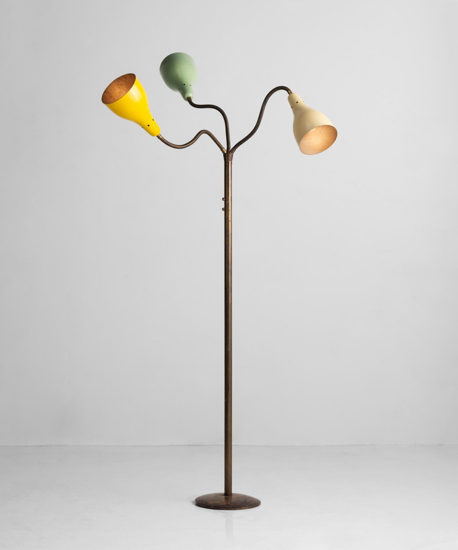 Adjustable modern floor lamp, Italy, circa 1950.

Patinated brass stand and base, with adjustable brass arms and painted metal shades.

Measures: 39