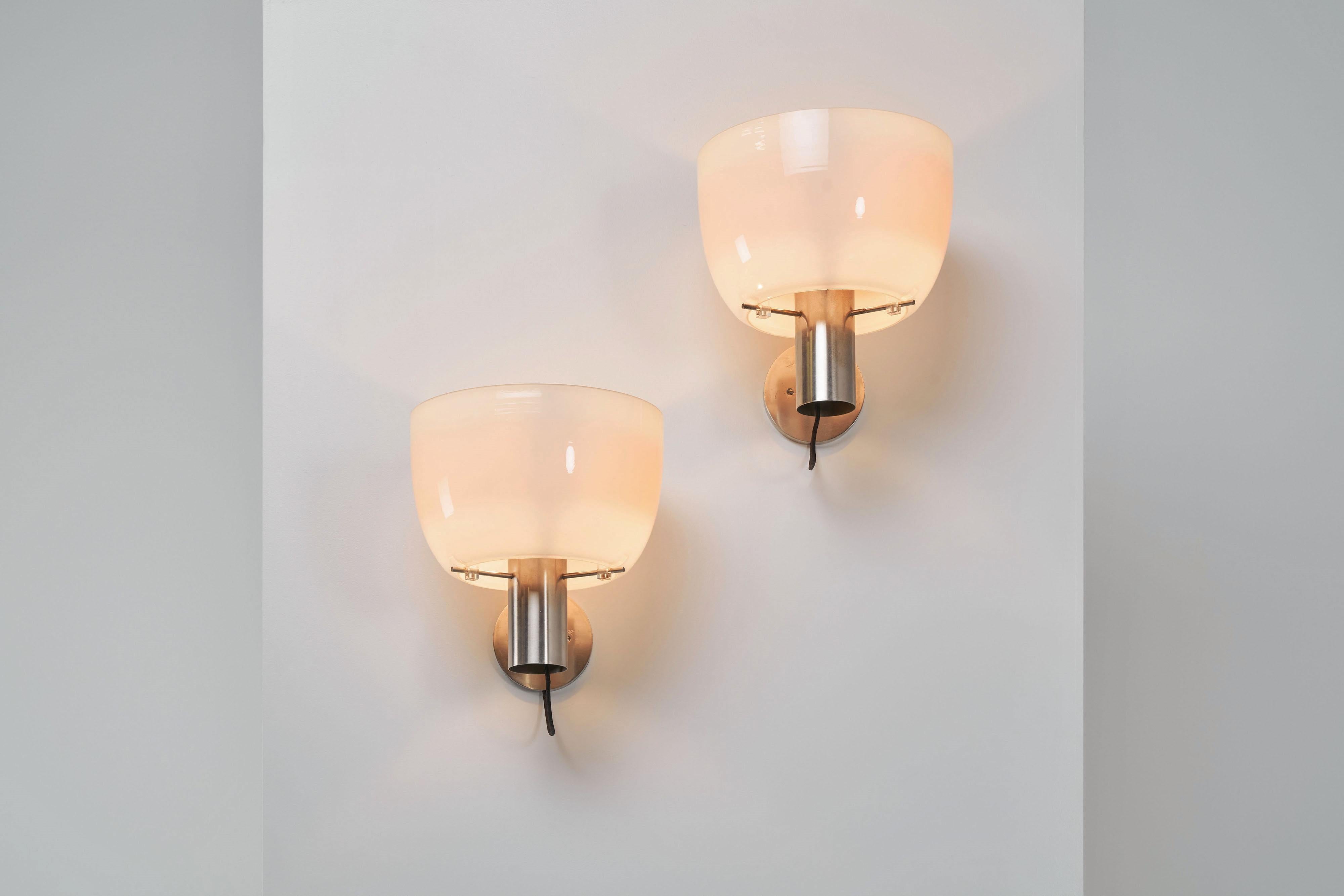 Rare big pair of wall lamps model 1121 designed by Giuseppe Ostuni and Renato Forti and manufactured by Oluce, Italy 1955. These minimalistic but very technical executed wall lamps have matt nickel-plated tructures, and they have a white blown glass