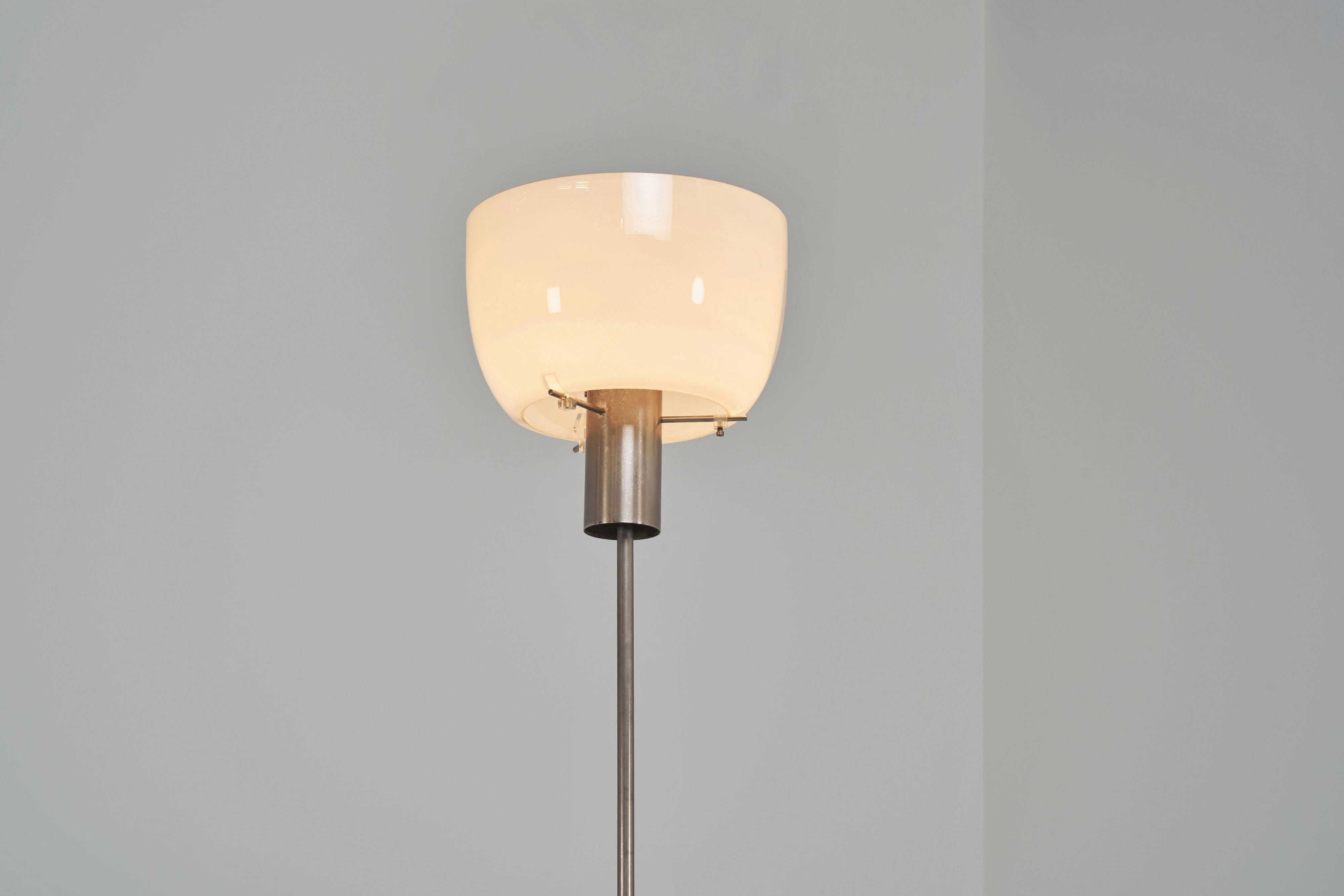 Rare collectible floor lamp model 3306 designed by Giuseppe Ostuni and Renato Forti and manufactured by Oluce, Italy 1955. This minimalistic floor lamp has a matt nickel-plated frame with heavy weighted base, and it has a white blown glass shade
