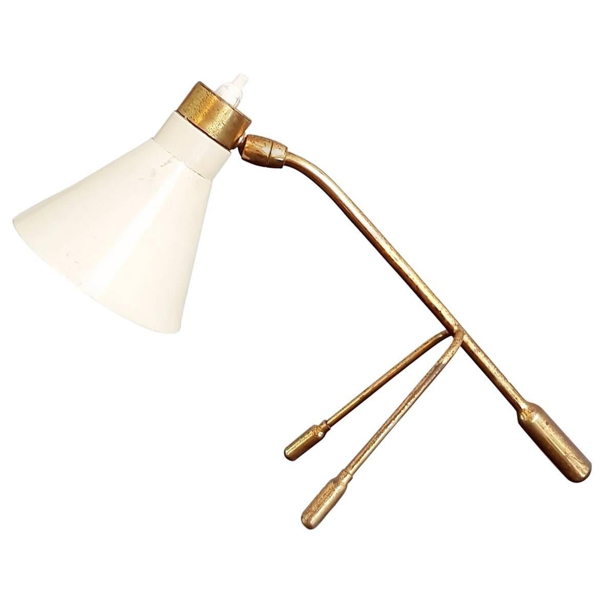 Table lamp with a tripod design in brass and a cream colored lampshade which is possible to direct in 360 degrees. In original working condition. Fitted for a e14 light bulb.

Brass can be polished and electric cable rewired if requested.
 