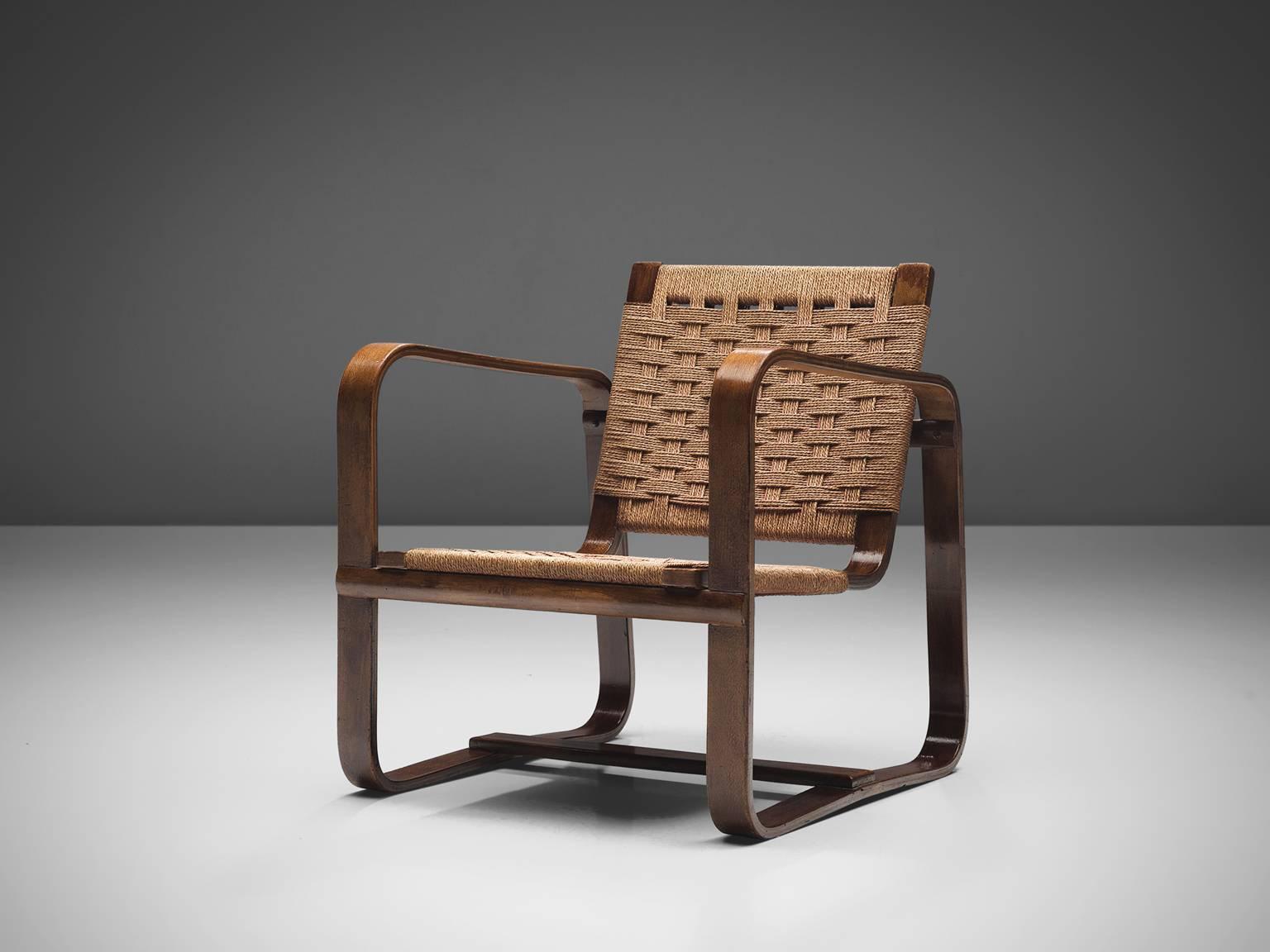 Giuseppe Pagano Pogatshnig, armchair, beech rope weave, Italy, 1942. 

This comfortable armchair made with layers of plywood has a boxy look has curved armrests. The design of this set of chairs and ottomans is Minimalist yet not in a Puritan way.