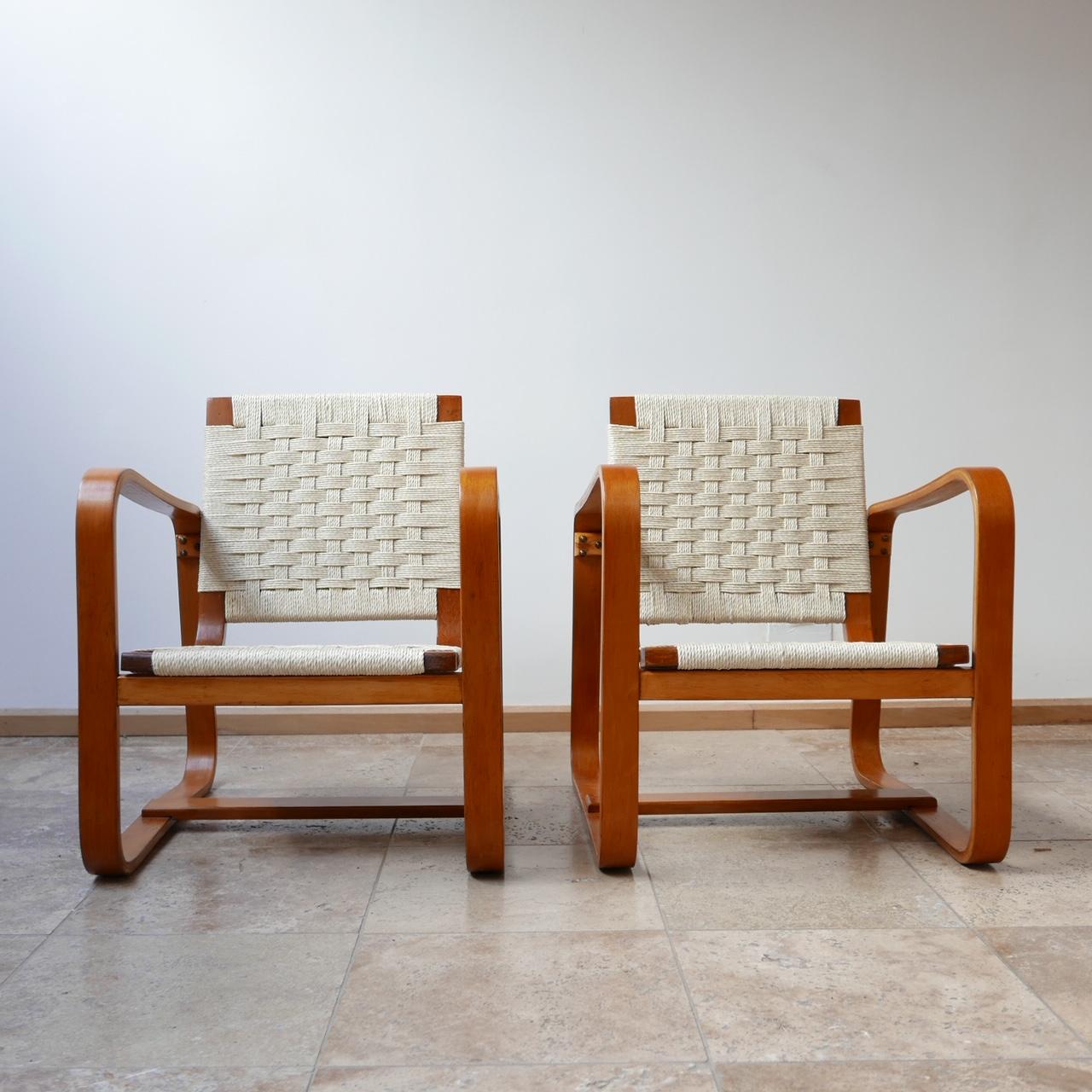 A pair of midcentury armchairs by Giuseppe Pagano.

Italy, circa 1942.

Minimalist curved design, formed from layers of plywood.

Brought as part of a suite so a small table

The seats have been re-corded professionally as such the armchairs