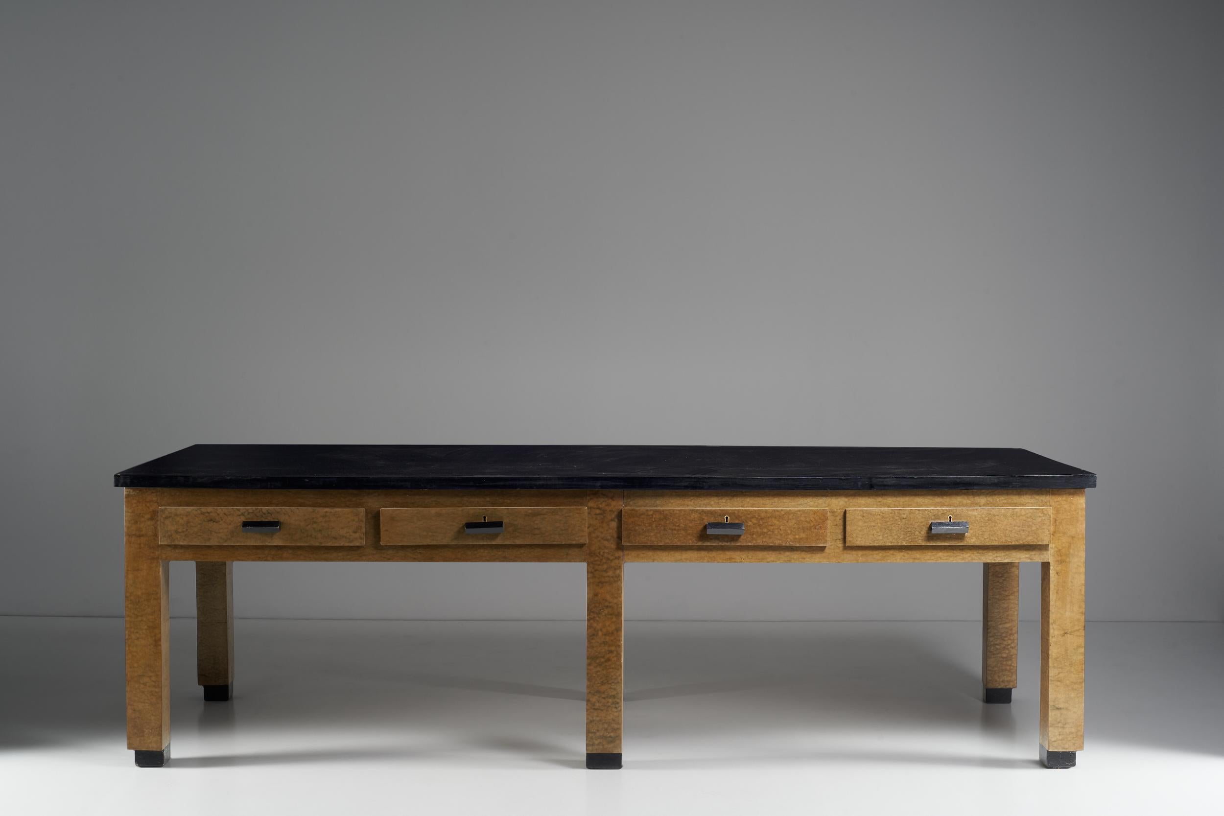 The immense accounting table designed by Giuseppe Pagano Pogatshnig and Levi-Montalcini, defined according to basic symmetrical criteria, is both a table deeply functional to the role for which it was created and extremely different. The