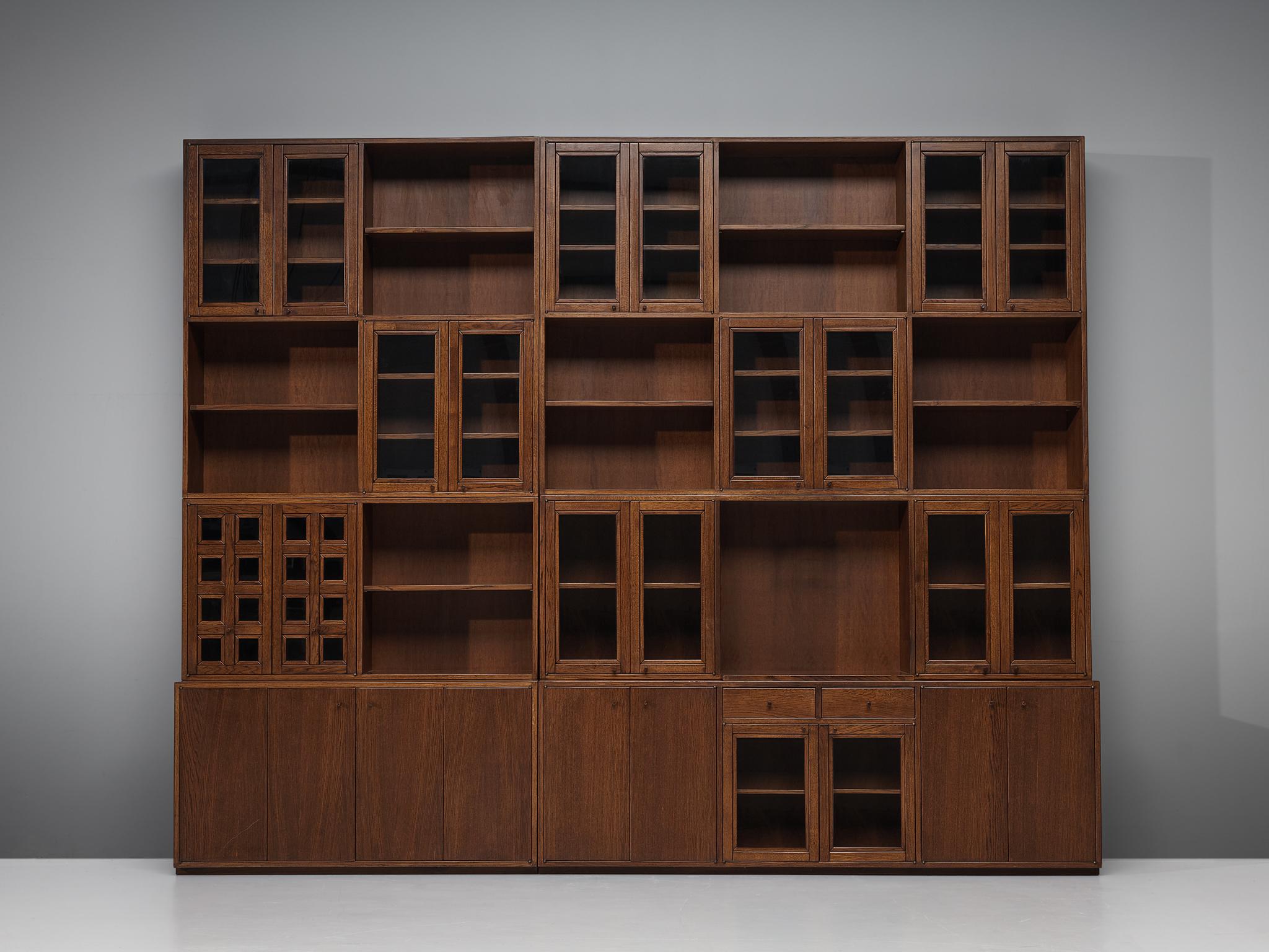 Giuseppe Rivadossi, pair of cabinets, oak, glass, Italy, 1975.

An exceptional library unit by the Italian sculptor and designer Giuseppe Rivadossi, featuring a high level of craftsmanship in woodwork. The two pieces combined create a wonderful wall