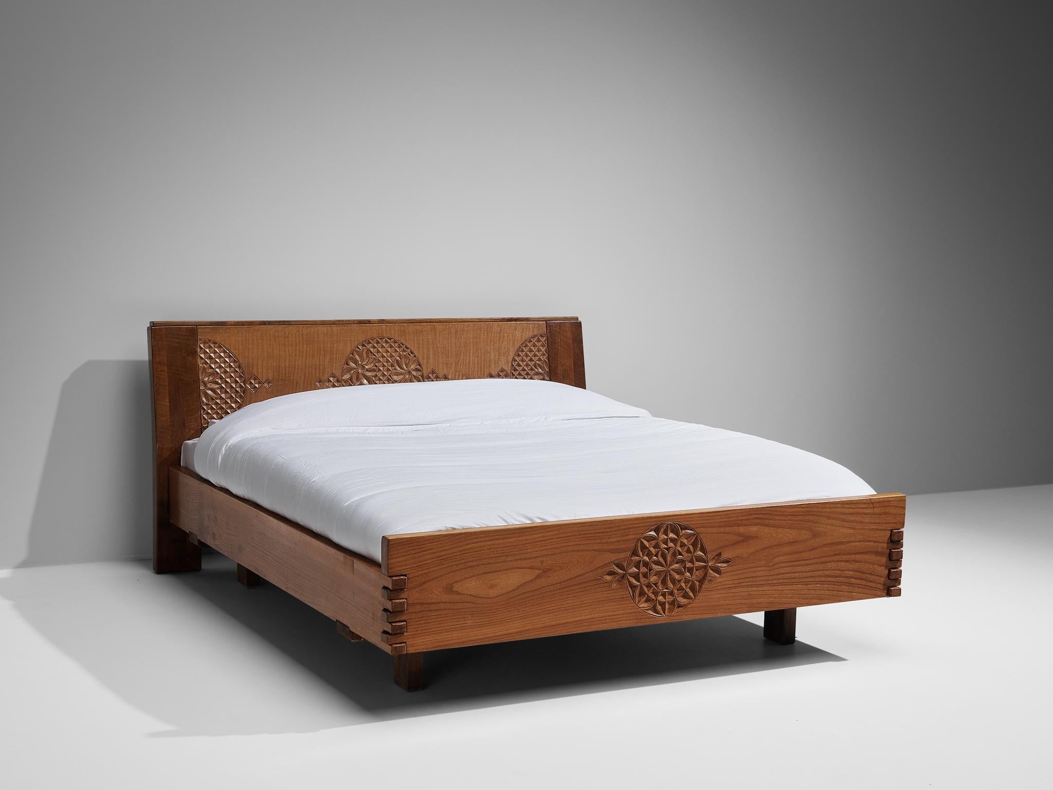 Giuseppe Rivadossi for Officina Rivadossi, king bed, walnut, Italy, circa 1980.

Giuseppe Rivadossi once again proves his great eye for materialization and technicality this bed is exemplary for. The bed is constructed using wooden panels secured