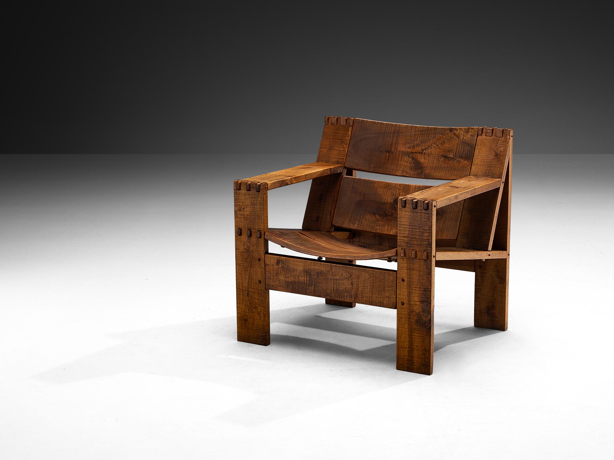 Giuseppe Rivadossi for Officina Rivadossi, 'Rocca' lounge chair, walnut, Italy, 1970s

Giuseppe Rivadossi’s Rocca chair is a prime example of Italian craftsmanship from the second half of the 20th century, when designers were mixing rugged materials