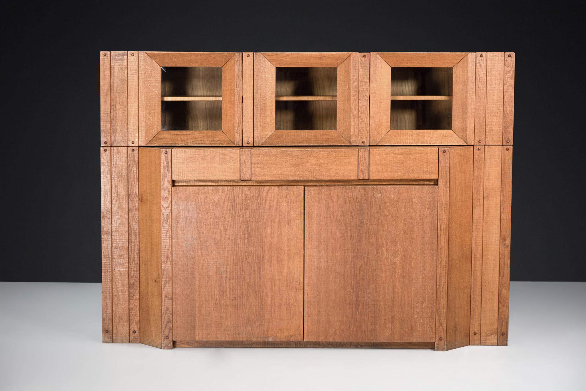 Giuseppe Rivadossi Glazed Credenza in oak, Italy, in the 1970s 

An exceptional glazed credenza/cabinet by the Italian sculptor and designer Giuseppe Rivadossi, featuring a high level of craftsmanship in woodwork. The lower part with three doors,