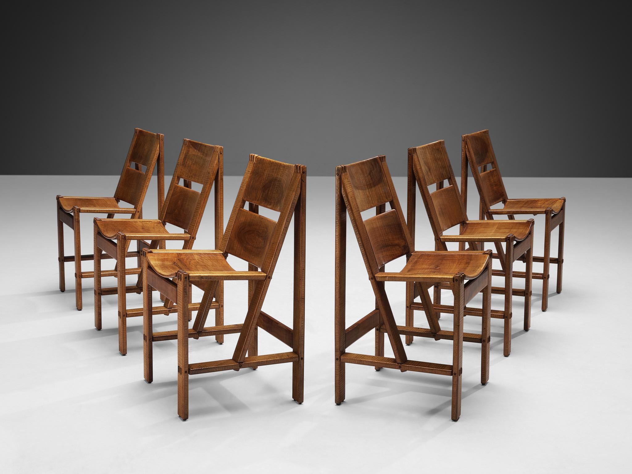 Giuseppe RIvadossi, set of six dining chairs, walnut, design 1962, production from 1968. 

Six dining chairs in walnut designed by the Italian designer Giuseppe Rivadossi. Defiant in design, these chairs are truly remarkable. The interesting