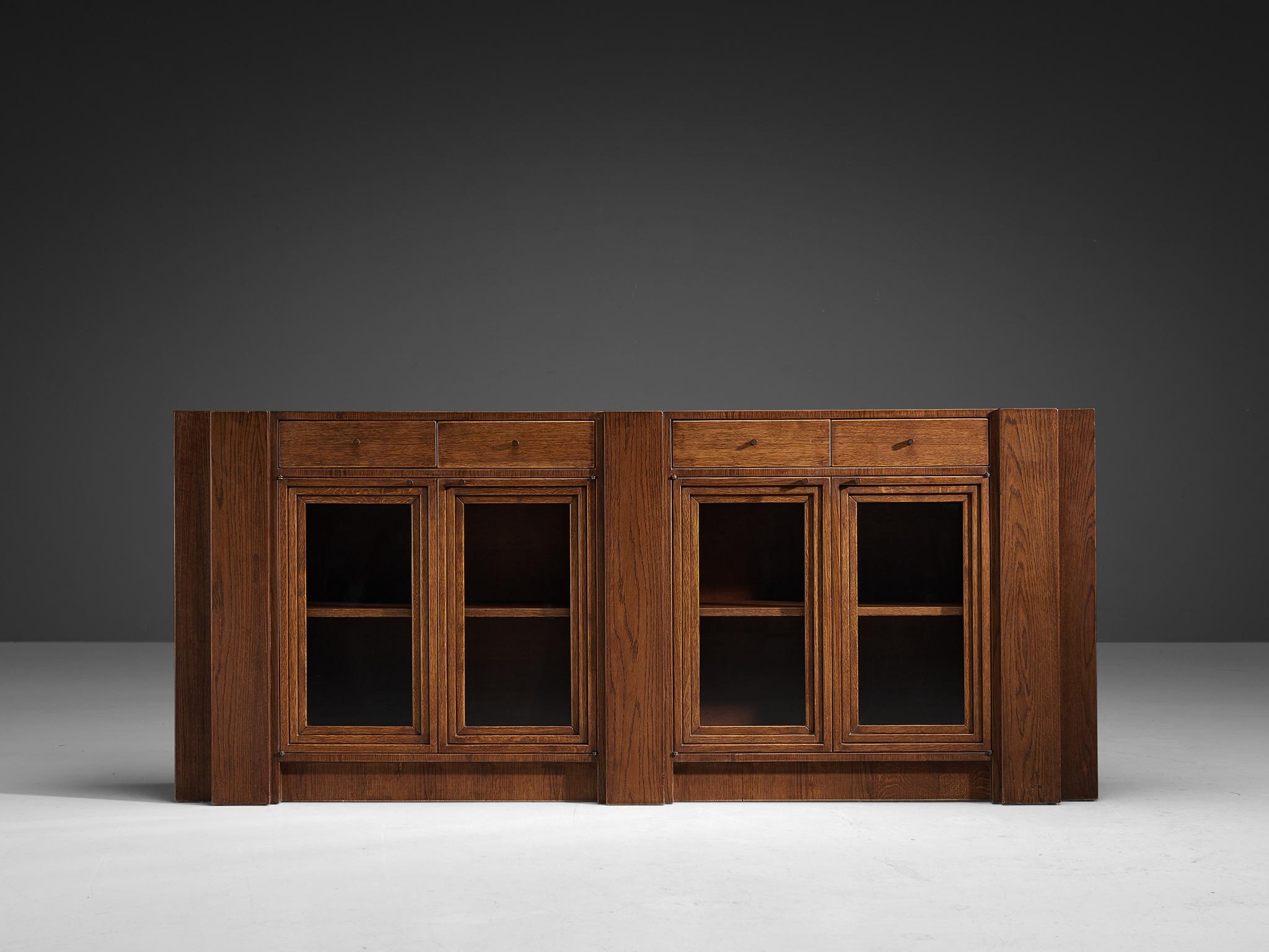 Giuseppe Rivadossi, sideboard, oak, glass, Italy, 1975

This striking sideboard by Giuseppe Rivadossi pleases the eye by all means. Rivadossi, an Italian sculptor and furniture designer, is known for his hand-carved wooden designs that combine a