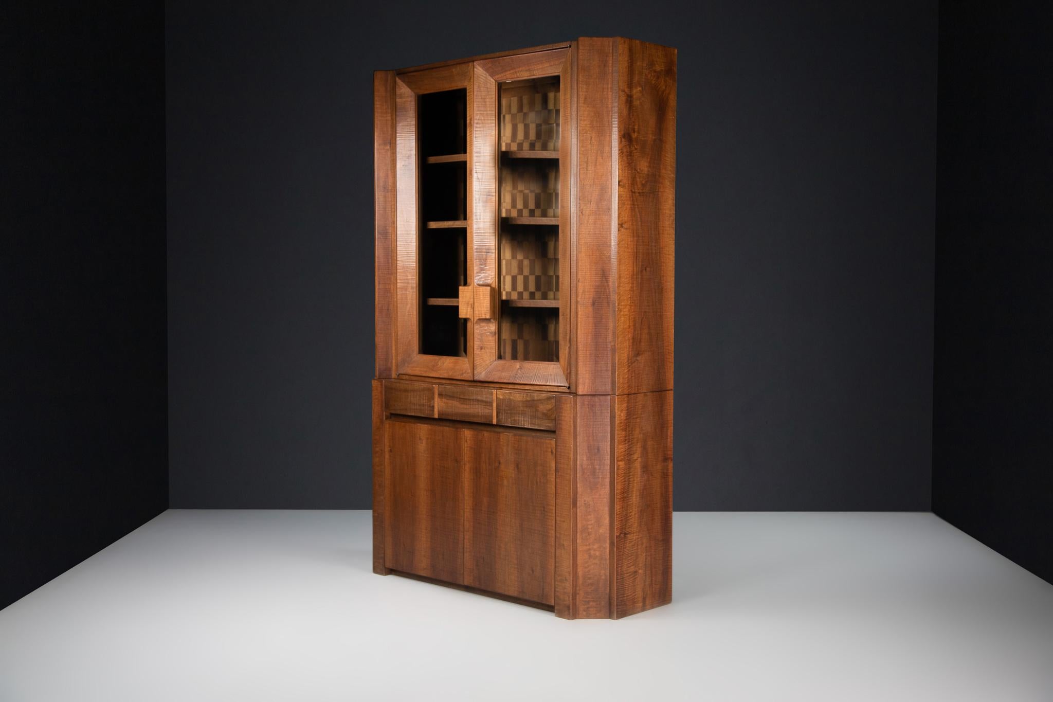 Giuseppe Rivadossi Tall Glazed Cabinet, Walnut, Italy, 1970s 

An exceptional tall glazed cabinet by the Italian sculptor and designer Giuseppe Rivadossi, featuring a high level of craftsmanship in woodwork. This piece comprises two sections: the