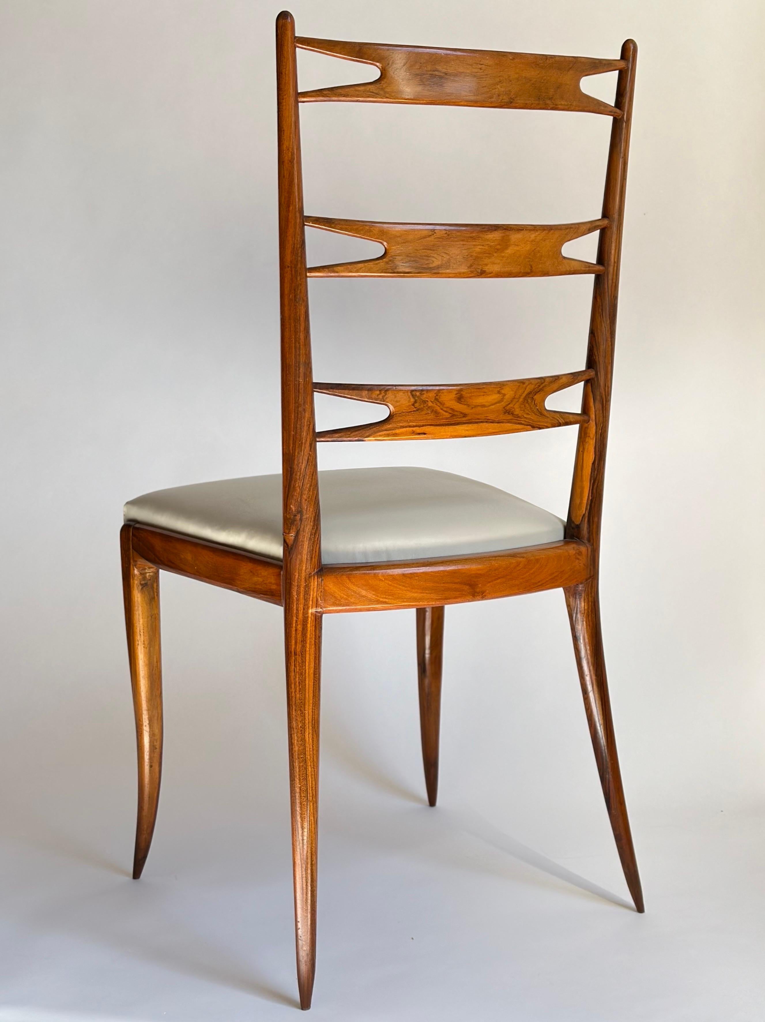 1950s modernist ladder-back chair executed in Brazilian rosewood with leather seat, designed by Giuseppe Scapinelli. Professionally restored with original patina left untouched and reupholstered in antique white leather. Retains partial label