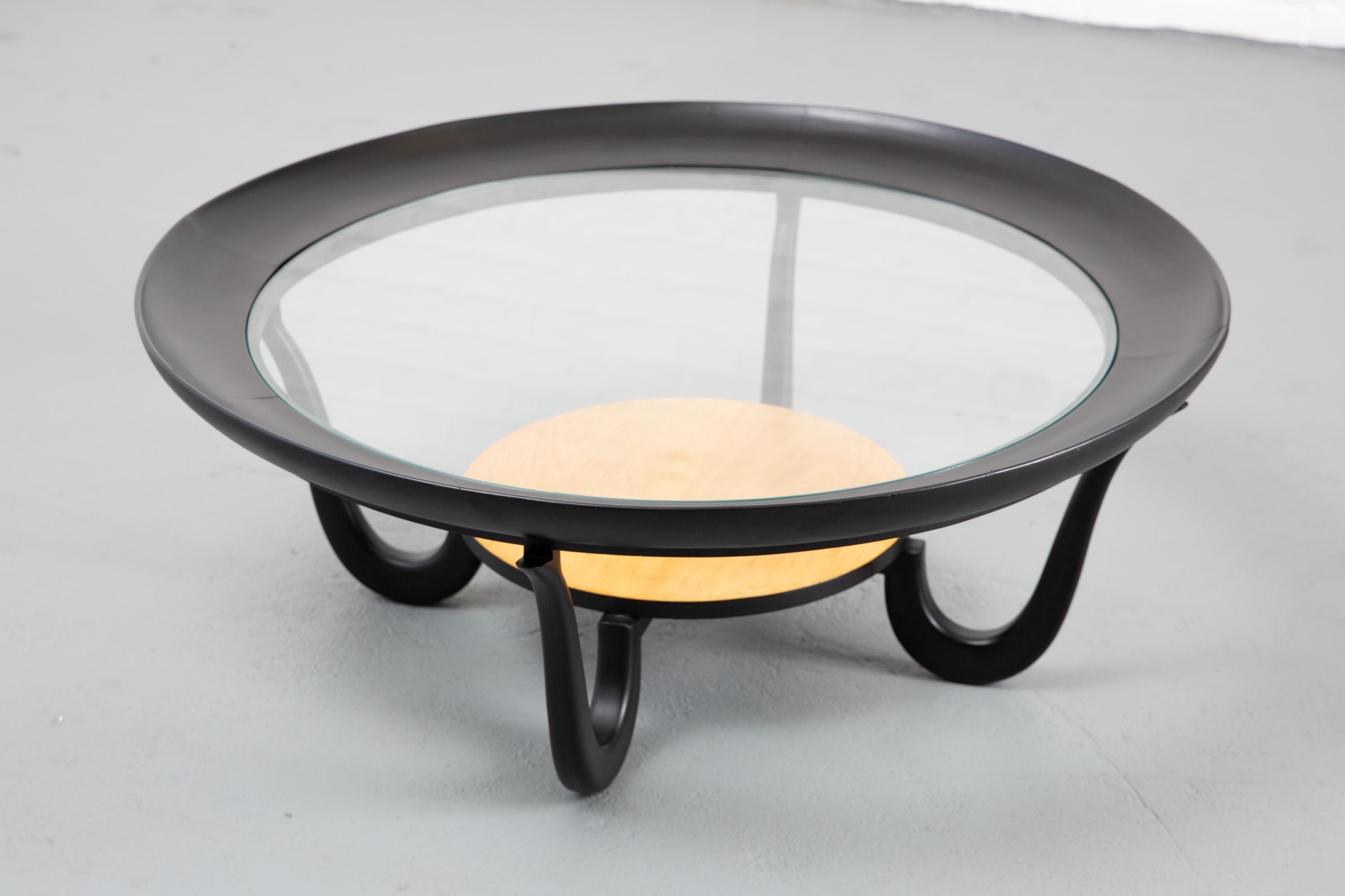 1950's round ebonized Giuseppe Scapinelli cofffee table with glass top and natural wood raised lower shelf. Beautiful curved 