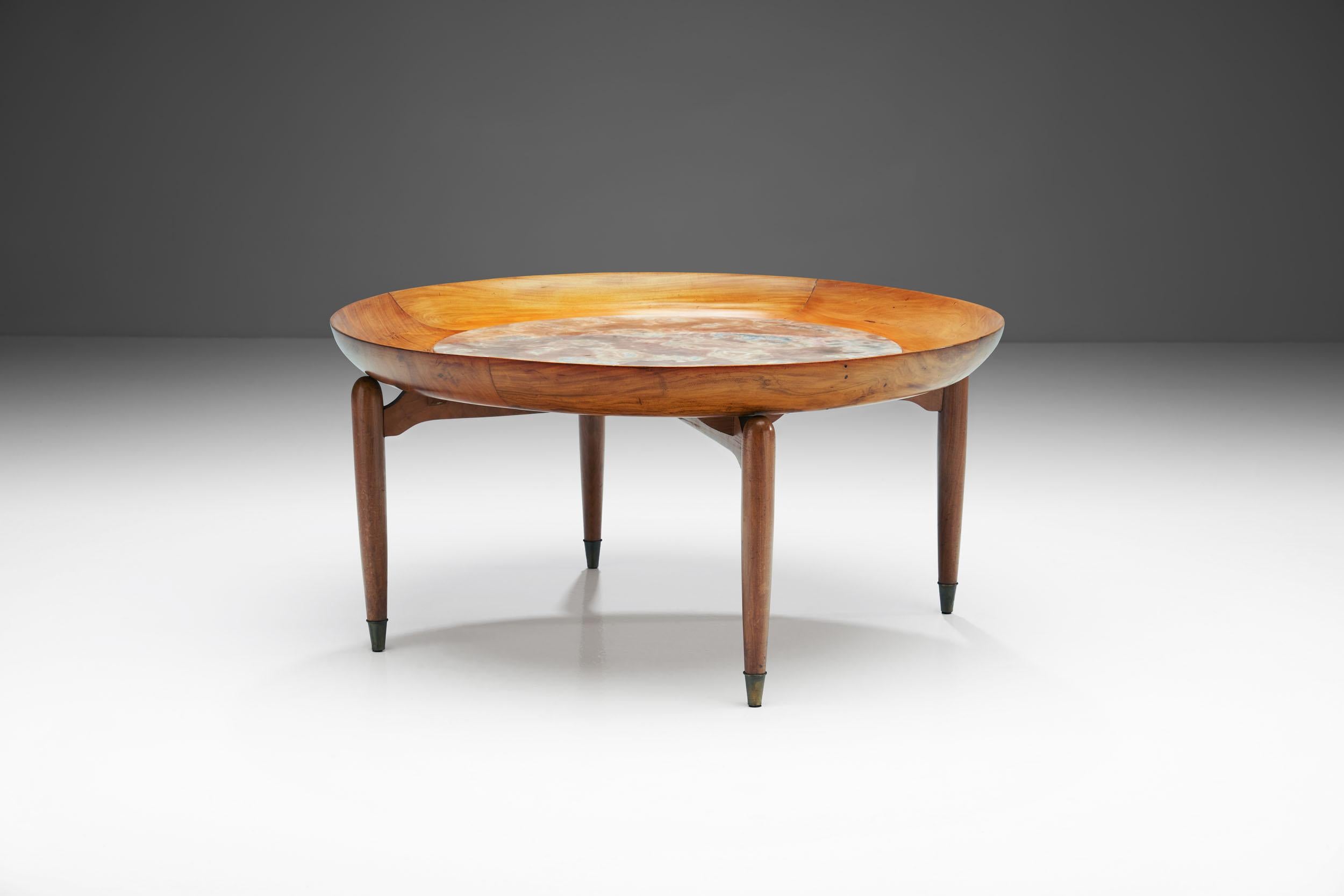 This Giuseppe Scapinelli round coffee table is made of caviuna wood and features a unique marble inlay. Scapinelli often combined ceramics and wood, and this table is among the most beautiful examples. 

This rare circular coffee table has a curvy