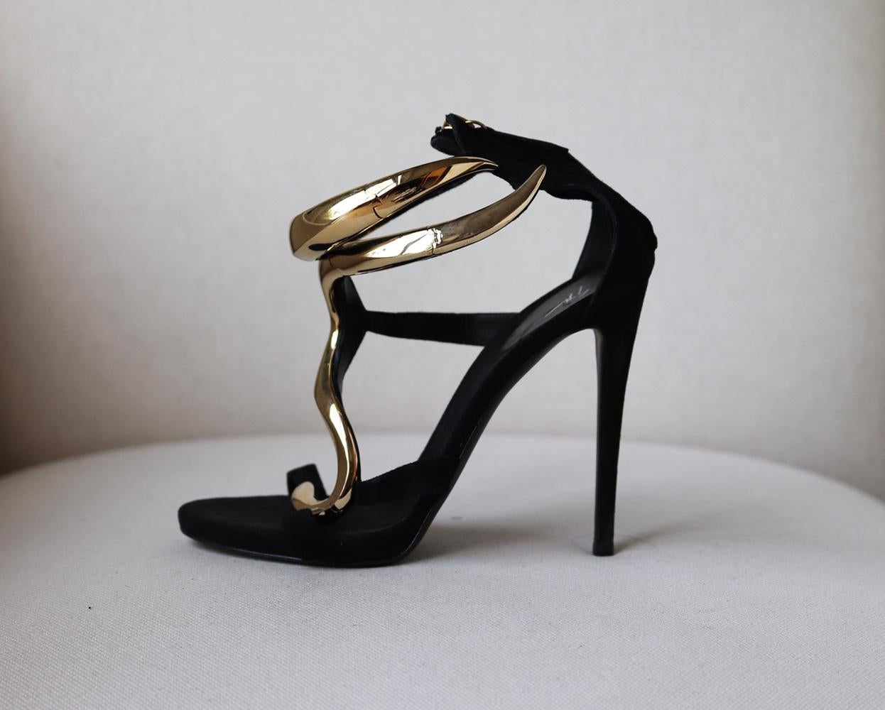 Aptly named 'Alien', Giuseppe Zanotti's sandals have an undeniable wow factor with a bold metal design down the front and platform to perfectly balance the vertiginous heel.
They're made from supple black suede and adorned with oversized polished