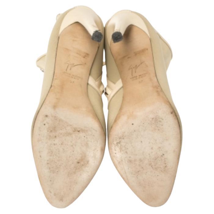 Comfort and luxe style are fused into this pair of ankle boots from Giuseppe Zanotti. Crafted from fabric, they carry metal detailing and leather trims. Covered toes, side zippers, and a set of 11 cm heels complete the boots.