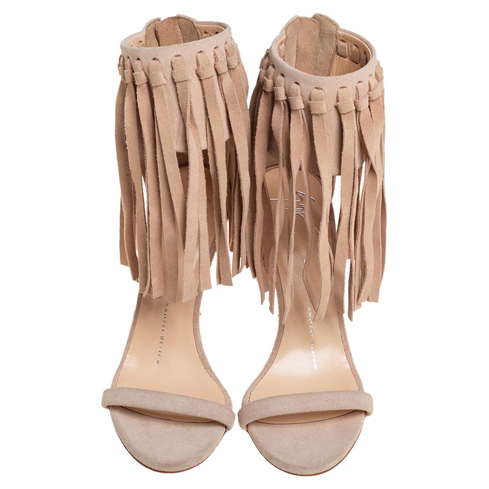 A perfect mix of elegant fashion and sensuous style, these Giuseppe Zanotti sandals come crafted from beige suede and detailed with fringe details and 10.5 cm high heels. These visually stunning and come with zip closures.

