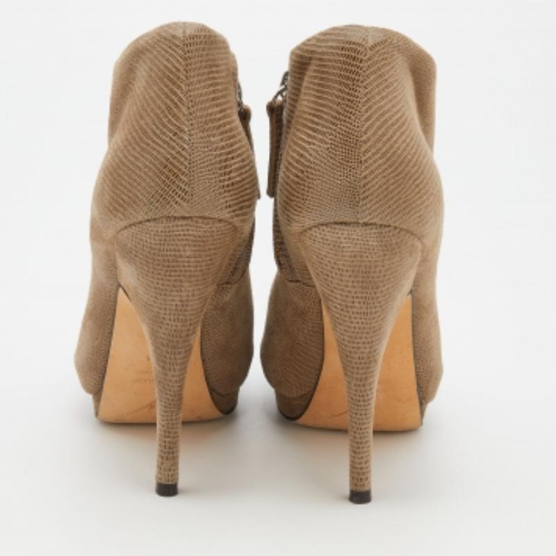 These chic ankle-length boots from Giuseppe Zanotti are all you need to make heads turn! They are crafted from suede and feature peep-toes. They flaunt zippers on the sides and come equipped with comfortable leather-lined insoles, 13 cm heels, and